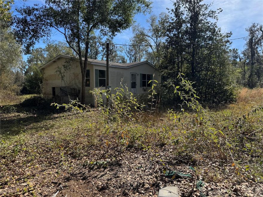 BEAUTIFUL WOODED 5.28 ACRES WITH 3/2 MANUFACTURED HOME. PROPERTY IS COMPLETELY FENCED WITH ENTRY GATE. SELLER HAS LEFT THE PROPERTY IN ITS NATURAL ENVIRONMENT, TREES SURROUNDED BY AZALEAS AND MAGNOLIA TREES, PERGOLA ON BACK OF HOME. DOUBLE DOORS OFF FAMILY ROOM LEADING OUT BACK, DOOR OFF LAUNDRY ROOM ALSO. LARGE KITCHEN WITH ISLAND AND EATING SPACE, FAMILY ROOM HAS WOOD WAINSCOTING, LARGE MASTER BATH WITH SHOWER & SEPARATE TUB, DINING ROOM HAS BUILT IN CORNER CABINETS WITH GLASS DOORS. THERE IS A POND ON THE BACK OF THE PROPERTY, WELL AND WATER TREATMENT SYSTEM IS INSIDE ONE OF TWO STORAGE BUILDINGS. BRING YOUR TOYS OR ANIMALS, PLENTY OF ROOM FOR BOTH. CALL TODAY FOR YOUR PERSONAL TOUR!