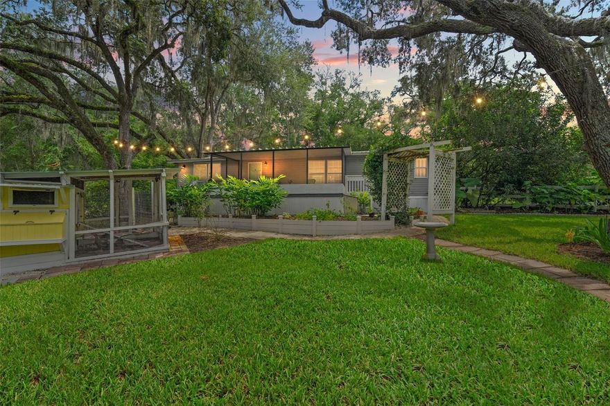 Tucked away on just over 4.5 acres of peaceful, park-like land, this fully renovated 2-bedroom, 2-bath retreat blends modern comfort with the charm of a true homestead. Backing directly to 132 acres of Central Ridge Park and only steps from the 46-mile Withlacoochee State Trail, it’s the perfect setting for those who love the outdoors, dream of hobby farming, or simply crave a slower pace of life. Inside, the home feels brand new thanks to a top-to-bottom renovation — from the plumbing, electrical, insulation, and drywall to the custom finishes that add warmth and character. The kitchen is designed for both function and hospitality, featuring GE Profile appliances, a GE Monogram double oven, custom cabinetry, and a spacious wood-top island with clever storage touches like a built-in knife drawer. A walk-in pantry, cozy electric fireplace with a live-edge mantle, and even surround sound over the soaker tub make every day feel like a treat. Step outside and the property comes alive with endless possibilities. A 20x40 irrigated and fenced organic garden is ready for your vegetables and herbs, while the chicken suite with cameras and an automatic electric door makes tending to your flock a breeze. Towering granddaddy oaks and fruit trees provide shade and beauty, while the above-ground pool with turf surround and a screened-in outdoor hangout provide the perfect place to relax any day of the week. For projects, storage, or future plans, you’ll appreciate the 16x32 shed with water and electric, RV/boat slab, barn or storage slab, and even a shooting range. An electric gated entry adds both privacy and convenience. The innovative ProVista lawn keeps the grounds looking lush with minimal effort, thanks to built-in weed control. With room for an additional homesite, the possibilities here are endless. Whether you’re dreaming of a thriving garden, collecting fresh eggs each morning, entertaining friends under the stars, or simply soaking up the peace of Florida’s natural beauty, this homestead offers a lifestyle that’s both laid-back and deeply rewarding — all delivered in style. FURNISHINGS OPTIONAL.