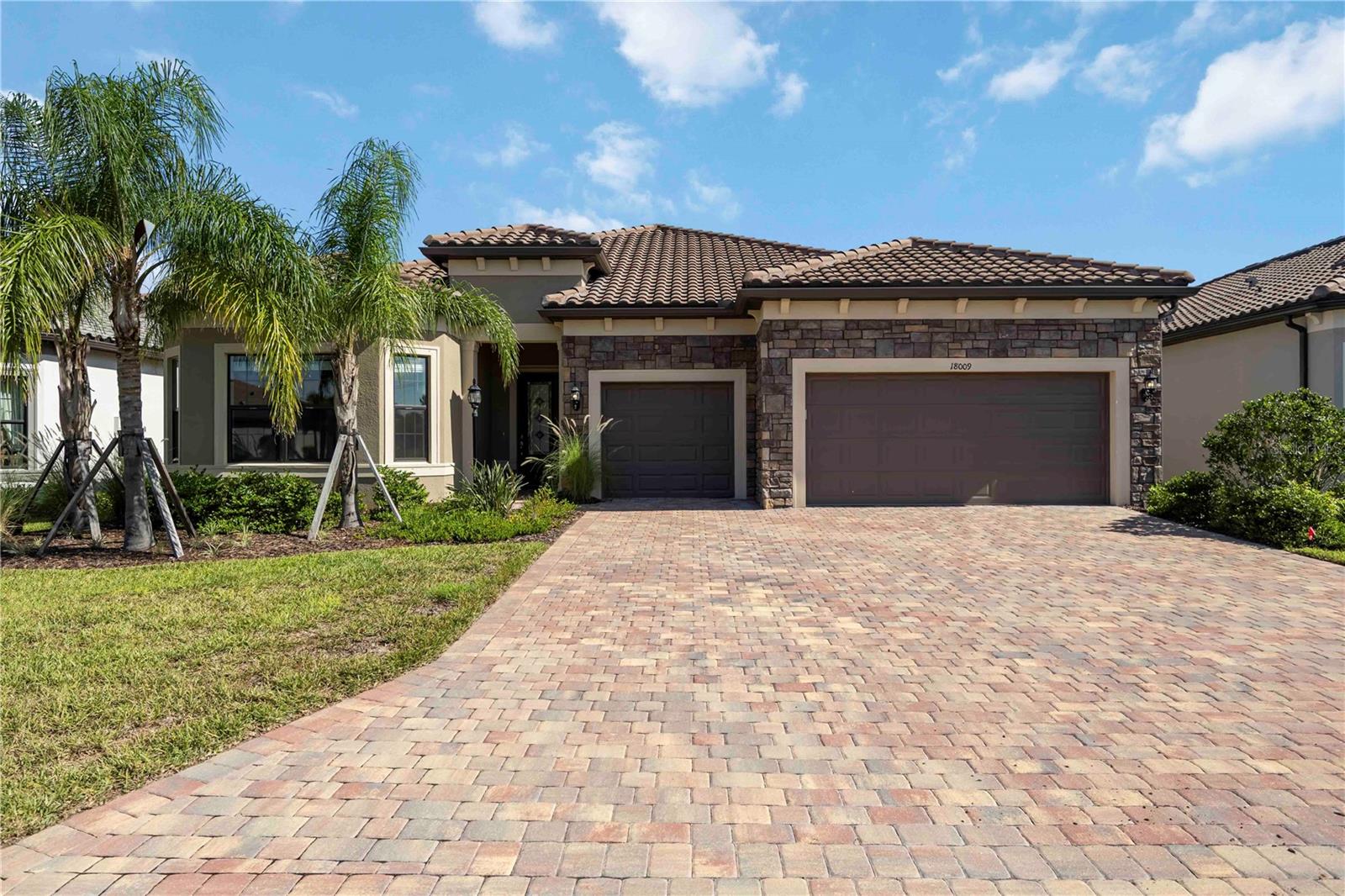 Impeccably designed and fully furnished, this Stellar floorplan home in Del Webb Lakewood Ranch offers lakefront luxury and resort-style living on a quiet cul-de-sac. Featuring 3 private en suite bedrooms, a flexible den/home office, a half bath, and a separate pool bath, this spacious home is ideal for comfort and entertaining. The chef’s kitchen showcases gray shaker cabinetry, granite countertops, gas cooktop, and a large center island—opening to the dining room with designer lighting and a stylish great room with coffered ceilings and luxury wood-look tile floors. Step outside to your screened lanai with an elevated spa, custom pool with water features, and a peaceful panoramic lake view. Whether enjoying coffee at sunrise or cocktails at sunset, this private oasis delivers a true indoor-outdoor lifestyle. The primary suite features water views, a large walk-in closet, and a spa-inspired bath with dual sinks and a walk-in shower and private water closet. Residents of Del Webb at Lakewood Ranch enjoy top-tier amenities: clubhouse, fitness center, on-site restaurant, resort-style pool, tennis, pickleball, and vibrant social calendar. Just minutes to Waterside Place, UTC, and Sarasota’s beaches. Offered furnished, available seasonally or annually. 55+ community. Schedule your private tour today!