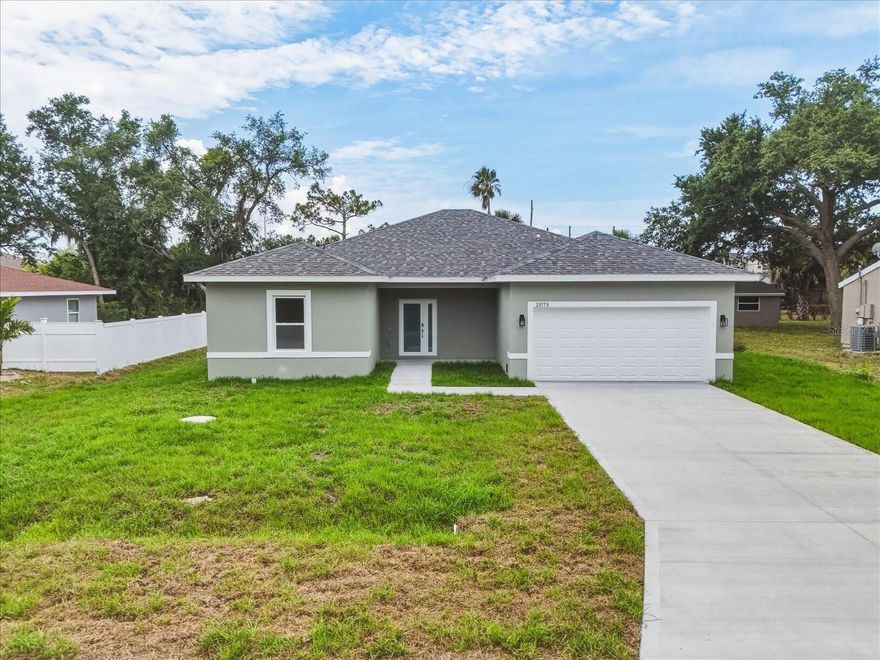 Welcome to this stunning newly completed 2026 residence located in the desirable Punta Gorda area, where modern design, quality craftsmanship, and Southwest Florida location come together effortlessly. Offering a spacious and thoughtfully designed layout, this home immediately impresses from the moment you arrive.
Step inside and you are welcomed by an expansive open-concept floorplan designed with both everyday living and entertaining in mind. The wide-plank luxury vinyl flooring create a seamless flow from room to room, while oversized hurricane-impact windows and sliding glass doors allow natural light to pour into the home. The living and dining spaces feel bright, comfortable, and connected, creating the ideal setting for hosting family and friends.
The kitchen serves as the centerpiece of the home and was designed to blend beauty with functionality. Featuring sleek quartz countertops, solid wood soft-close cabinetry, premium finishes, and an oversized center island with additional seating, this space effortlessly becomes the heart of daily life. A spacious walk-in pantry provides ample storage while maintaining the kitchen’s clean and organized aesthetic. Just nearby, the laundry room is conveniently tucked away for added practicality.
Large sliding glass doors open to the lanai, extending the living space outdoors and embracing the Florida lifestyle. The backyard offers endless possibilities with plenty of room to design your dream outdoor oasis — whether that includes a future pool, outdoor kitchen, firepit area, or lush tropical landscaping. The patio creates the perfect environment for relaxing mornings, outdoor dining, or entertaining year-round.
Privately positioned within the home, the primary suite offers a peaceful retreat filled with natural light and generous space. The ensuite bathroom showcases a luxurious spa-inspired design complete with dual vanities, abundant cabinetry for storage, an elegant freestanding soaking tub, and a large walk-in shower. Completing the suite is an oversized walk-in closet designed to accommodate both storage and organization with ease.
The additional bedrooms are thoughtfully arranged on the opposite side of the home, providing comfort and privacy for guests or family members. Two bedrooms are connected by a spacious Jack and Jill bathroom, while each room offers built-in closets and flexible functionality for guest accommodations, home office space, fitness rooms, or hobbies.
Adding even more convenience, the home includes a two-car garage with room for vehicles, tools, storage, or additional workspace.
Beyond the property itself, the location places you close to some of the very best that Punta Gorda has to offer. Enjoy being just minutes from vibrant downtown Punta Gorda, known for its waterfront restaurants, charming boutiques, weekend farmers markets, parks, and lively community events. The home is also conveniently located near the highly sought-after Sunseeker Resort Charlotte Harbor, offering upscale dining, entertainment, rooftop experiences, and waterfront attractions. Golf enthusiasts will appreciate easy access to Twin Isles Country Club, while nearby highway access allows for convenient travel to both Fort Myers and Sarasota for additional shopping, dining, beaches, and entertainment options.
Combining the peace of mind of brand-new construction with high-end finishes this home offers the perfect opportunity to enjoy everything Southwest Florida living has to offer.