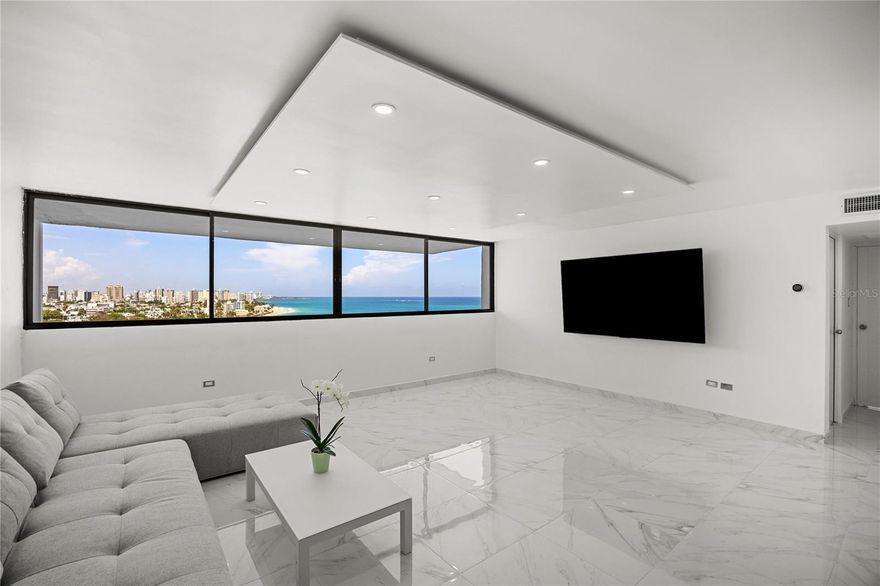 Set between Santa Teresita and Punta Las Marías, The Terrace offers a quieter, more residential take on beach living, just a block from the shore and defined by a relaxed coastal atmosphere. One of the few taller buildings in the area, it stands apart for its scale while maintaining a low-density feel, with only six apartments per floor. Residents include a mix of locals, young professionals, and newcomers drawn to the neighborhood’s proximity to the water and its unpretentious, active lifestyle.  

This particular residence is positioned on the 12th floor, with open views enhanced by both height and orientation. The apartment has been fully remodeled and presents a clean, modern aesthetic: large-format ceramic tiles, smooth white walls, recessed lighting, and a sleek kitchen in gray tones with black quartz countertops and new appliances. The overall look is sharp and contemporary, with a restrained palette that feels intentional and well executed.  

Offered for rent partially furnished, the unit includes new living room pieces (sofa and coffee table), a master bed, and updated appliances, along with central air conditioning. The building features a pool and grilling area to the rear. The rent includes one parking space, with a second available for an additional $135 monthly.  The Terrace presents a well-executed, move-in-ready residence for those who value clean design, elevation, and proximity to the water.