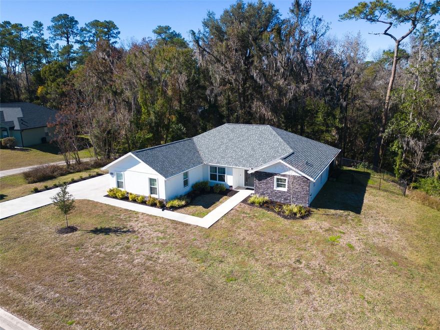 Step into this beautifully crafted 2023 home located in a serene gated community in Belleview, Florida. Thoughtfully designed and gorgeously appointed, the home features high-end stone countertops, a classic subway-tile backsplash, and a spacious kitchen island that opens seamlessly to the generous living room—perfect for everyday living and effortless entertaining.

French doors lead you from the living area to a peaceful screened lanai overlooking a lush wooded backdrop. With nature surrounding you, this space becomes an ideal retreat for morning coffee, evening relaxation, or simply enjoying the quiet beauty of the outdoors.

The split-bedroom floor plan offers privacy and comfort, with large guest rooms and a tastefully finished guest bath. The indoor laundry room provides ample storage, and the kitchen includes a versatile secondary workspace—ideal as a dry bar, coffee station, or mini butler’s pantry.

Located on a cul-de-sac, the home enjoys a wonderfully quiet setting. Just two blocks away, Cobblestone Park invites residents to gather, unwind, and enjoy the swings, green space, and room to play fetch with your four-legged friend. With two gated entrances and an easy 15-minute drive to both Ocala and The Villages, the location offers convenience without sacrificing tranquility.

A modern home, a peaceful community, and nature at your doorstep—this Belleview gem truly has it all.