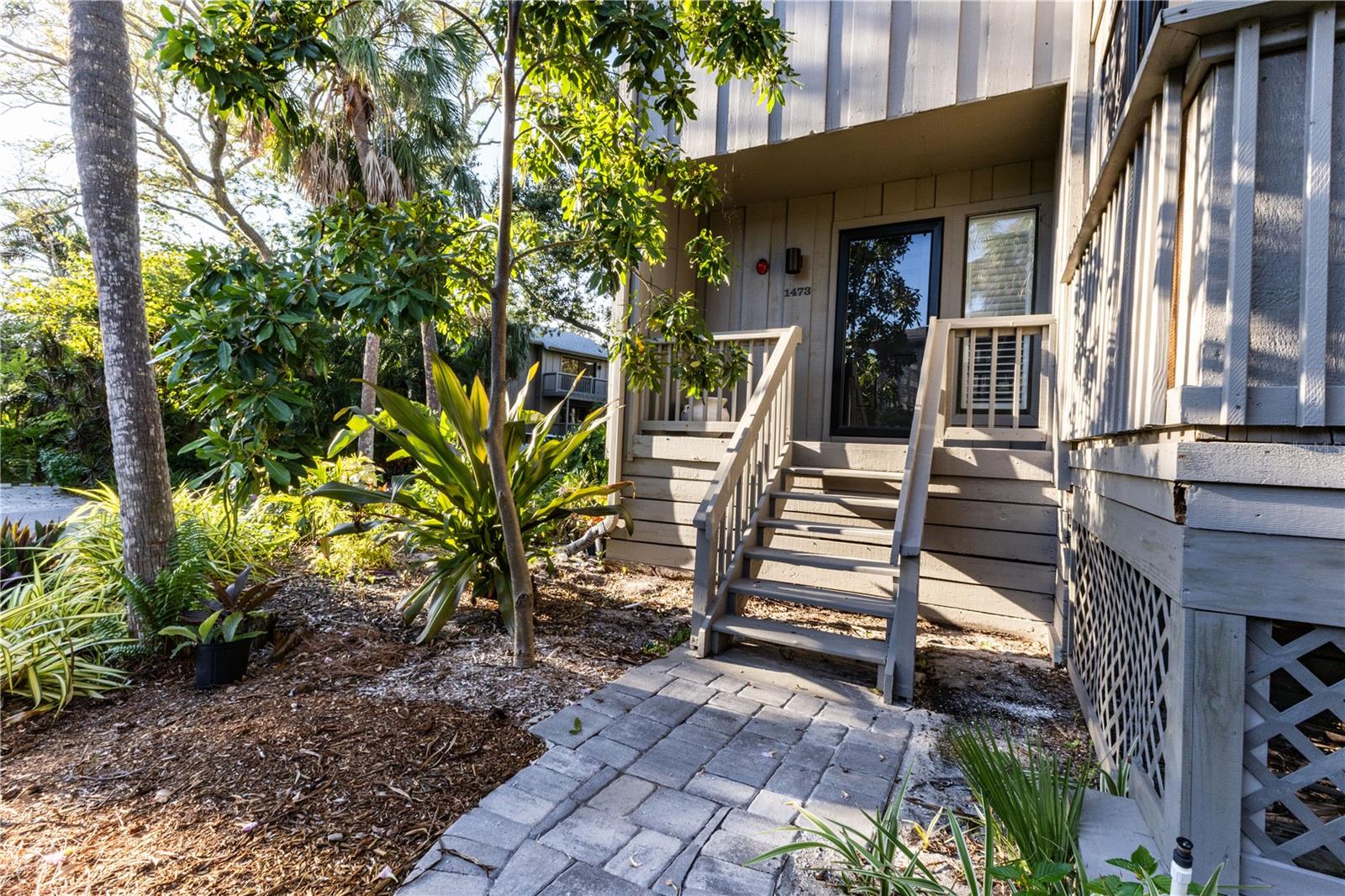Welcome to The Landings Treehouse, one of Sarasota’s most sought-after gated communities. This spacious 3-bedroom, 2.5-bath residence offers over 2,000 sq. ft. of living space with a thoughtfully designed open floor plan that balances comfort and style. The main level features a bright living and dining area with soaring ceilings, skylights, a cozy fireplace, and access to a private lanai surrounded by lush tropical landscaping. The updated kitchen boasts granite counters, a center island, breakfast bar, solid wood cabinetry, and stainless-steel appliances—perfect for both everyday living and entertaining.
Upstairs, the primary suite offers a walk-in closet, high ceilings, and a spa-inspired bathroom with skylights that fill the space with natural light. Two additional bedrooms provide plenty of room for guests, one with its own en suite bath. Throughout the home, you’ll find luxury vinyl and tile flooring, designer finishes, and built-in features that enhance functionality.
Set among mature trees and serene nature, The Landings Treehouse community is known for its exclusive amenities, including a heated community pool, tennis courts, walking trails, and private access to the Intracoastal Waterway through the Landings Racquet Club (membership optional). This desirable location places you just minutes from Siesta Key Beach, Downtown Sarasota, St. Armands Circle, and a variety of shopping, dining, and cultural attractions.
With its generous floor plan, resort-style amenities, and unbeatable location, this home is the perfect opportunity to enjoy the relaxed yet vibrant Sarasota lifestyle.