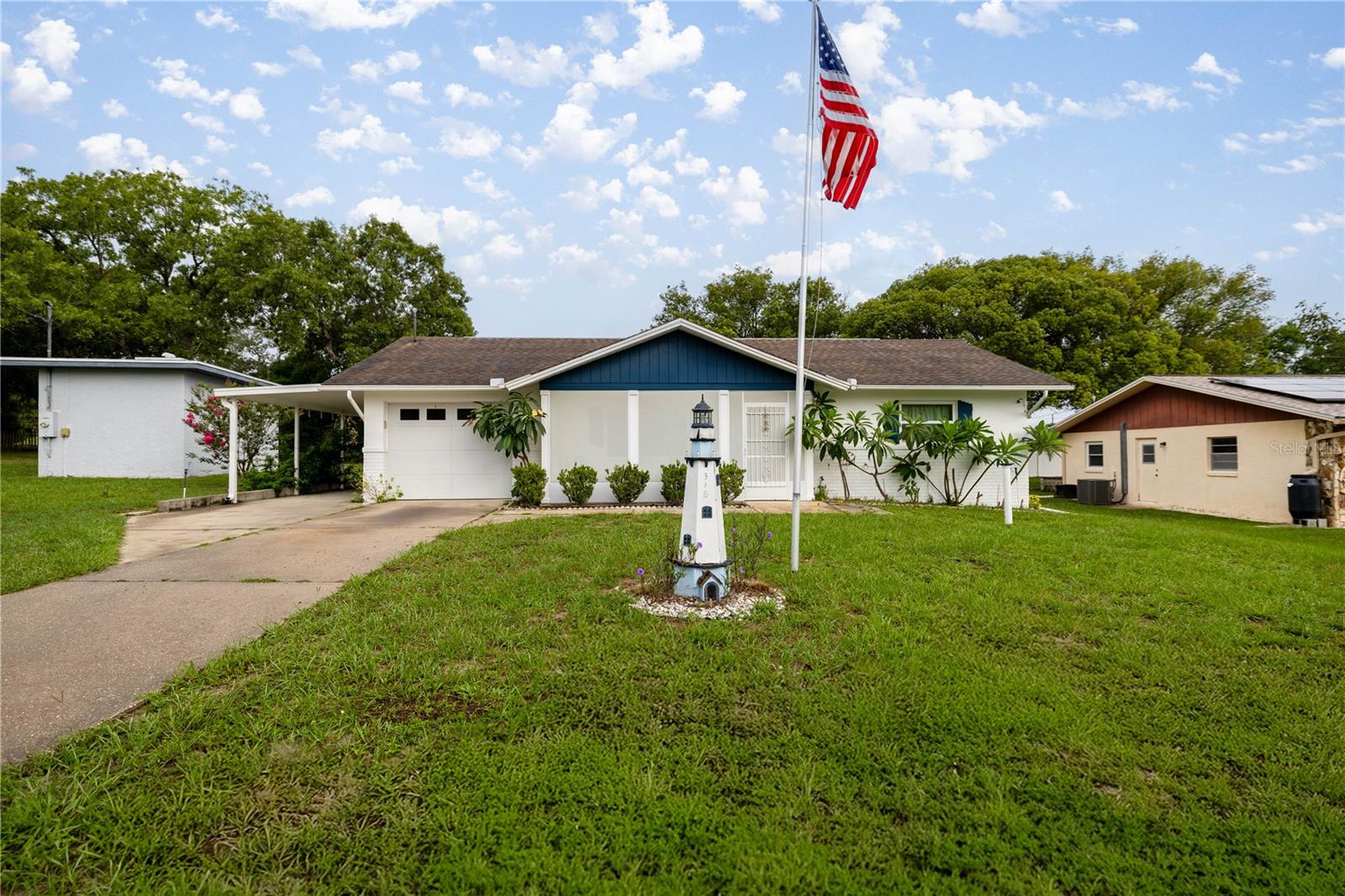 Welcome to this charming corner-lot home, nestled on a spacious, fully fenced yard offering privacy and outdoor enjoyment, complete with lime, lemon, and berry trees. This 2-bedroom, 2-bath home features generously sized bedrooms, a bright Florida room perfect for a home office, playroom, or additional living space, plus a screened front balcony and screened lanai ideal for relaxing or entertaining. The functional galley kitchen provides ample cabinet space for all your cooking and storage needs. The garage has been thoughtfully converted into a heated and cooled bonus room with a private bathroom and laundry area—perfect for guests or extended family—and can easily be converted back into a traditional garage. The remaining garage space serves as an attached storage area, and additional storage is found throughout the home. A 1-car carport adds covered parking for convenience. Don’t miss this versatile and inviting property—schedule your showing today!