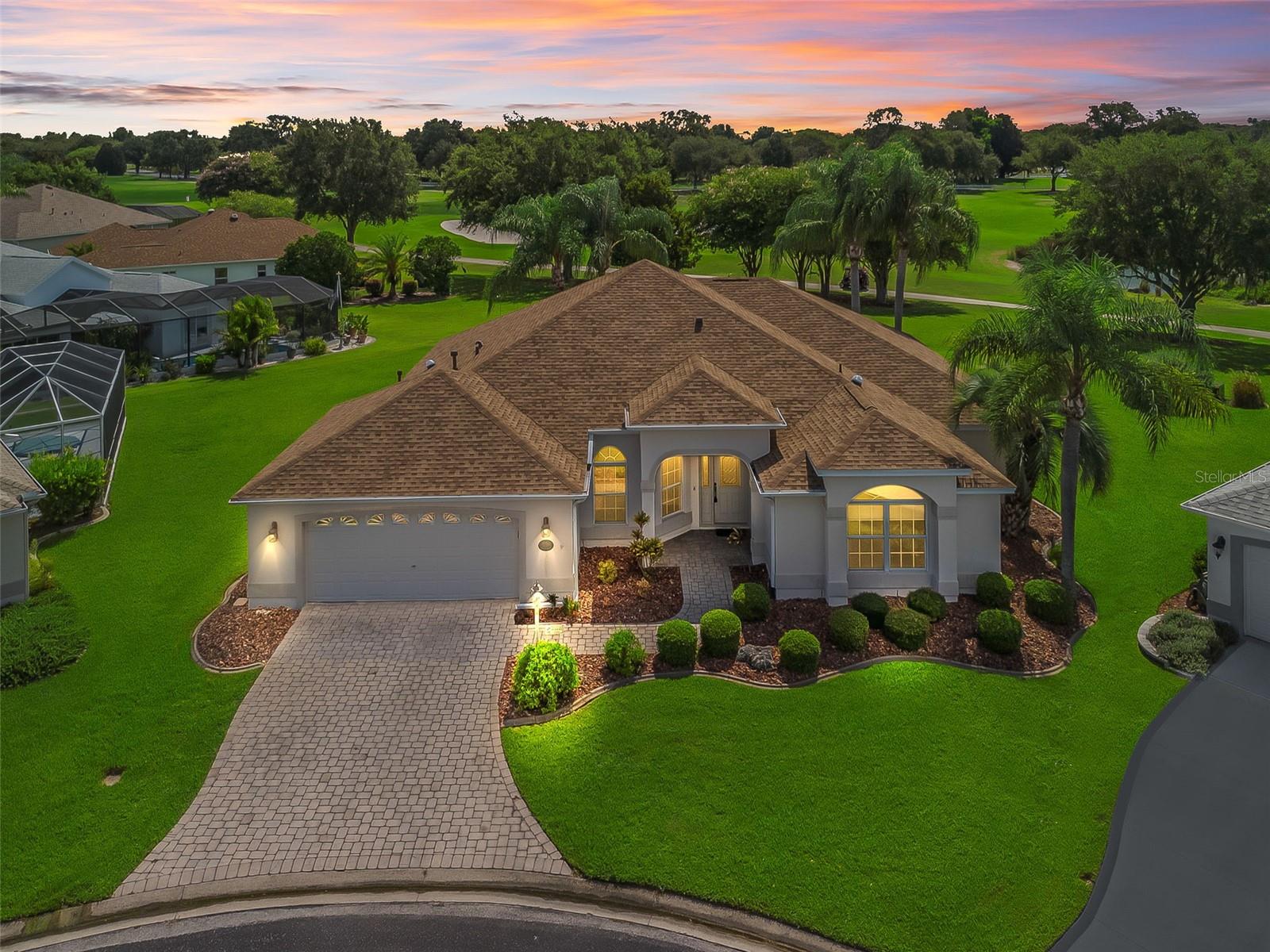 One or more photo(s) has been virtually staged. CUSTOM Magnolia Model with PANORAMIC GOLF & WATER VIEWS – AND PRIVACY! Must See! NO BOND! A designer home customized with PREMIER features with ROOM FOR A POOL!
Welcome to this stunning home nestled on an oversized lot at the end of a quiet CUL-DE-SAC. Enjoy breathtaking views of the golf course and water from every room in the rear of the home—all while being less than a minute from shopping, dining, and essential amenities.
Curb appeal abounds with a PAVER STONE drive/walkway and lush TROPICAL landscaping. Step inside to discover a thoughtfully designed open-concept layout featuring 12’ ceilings, BULLNOSE corners, and TRANSOM windows above QUAD sliding glass doors (retractable), flooding the living space with natural light.
This unique home includes a SOUNDPROOF MEDIA ROOM with ELEVATED flooring, a split-bedroom floor plan with FLEXIBLE 3rd bedroom/office PLUS a sunroom/den with separate access to the lanai. A 2024 roof with a GOLD PLAN 25/50 Year Warranty provides peace of mind! The 3-zoned AC system, SOLAR tubes, and AIR FILTRATION SYSTEM allow sunlight and clean fresh air throughout.
The chef’s kitchen features an EAT-IN area, large breakfast BAR with judges paneling, CORIAN countertops, abundant cabinetry with pull-out shelves, a Whirlpool French door refrigerator, GE Profile range & microwave, Kenmore dishwasher, and seamless sink.
The primary en-suite is a private retreat with HIS & HER WALK-IN closets, DUAL sinks, makeup area, WALK-IN shower, and an oversized linen closet.
Guests and family will enjoy generously sized bedrooms and a full bath with a shower/tub combo.
The spacious and extended lanai features a large screened birdcage with a covered seating area—perfect for entertaining or relaxing while enjoying serene views.
ADDITIONAL HIGHLIGHTS - New 2024 Rheem Water Heater, EXPANDED 2-Car Garage with BUILT-IN Workbench Areas, Recessed Lighting and Slider Light Switches, Large Hall Closet, and a Beautiful Mix of Diagonal Tile and Newer Carpet.
This home truly combines luxury, comfort, and functionality in a premium location. Ask for the detailed feature sheet and schedule your private tour today—this one won’t last! Convenient and less than a minute from Highway 466 where all shopping, banking, and amenities are located!