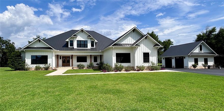 Experience refined country living in this remarkable custom-built home located within the prestigious, gated Charleston neighborhood. Set on over 6 acres, this 4-bedroom, 3.5-bath residence includes a private study, entertainment room, loft, and dedicated storage space—offering luxury and flexibility for any lifestyle. Step inside through an impressive entryway that reveals soaring 23-foot ceilings adorned with cypress tongue-and-groove accents. Rich wood floors flow throughout the home, complemented by a show-stopping staircase featuring floating solid walnut treads. The gourmet kitchen is designed for both entertaining and everyday living, featuring a large center island, high-end gas range, butler’s pantry, and a coffee/wet bar for added convenience. The open-concept layout seamlessly connects to the great room, where walls of glass overlook the spectacular outdoor oasis. The primary suite is a true retreat, complete with vaulted ceilings, private glass doors leading to the pool area, and a spa-inspired en-suite bathroom. Highlights include a glass-enclosed shower, dual vanities, and a dream-worthy custom walk-in closet with built-in cabinetry and direct access to the laundry room.
Step outside to your own private paradise: a screened saltwater pool with hand-built cypress trusses and extensive travertine decking—perfect for year-round enjoyment. Additional features include two tankless water heaters, full-house generator hookup, Central vacuum system and water softener. Four-car garage, large underground propane tank and Horse-friendly property. This home offers a rare blend of luxury, functionality, and space—truly a must-see.