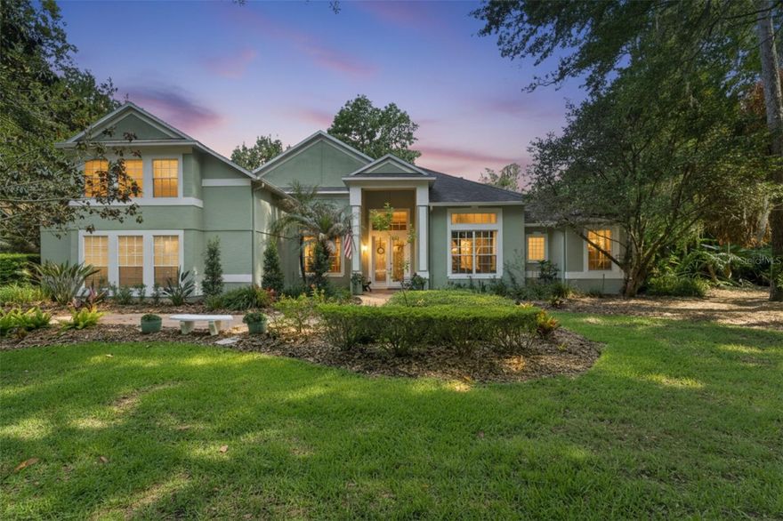 LUXURY ESTATE IN GATED RESERVE AT TUSCAWILLA WITH RESORT-STYLE OUTDOOR OASIS DESIGNED FOR ENTERTAINING. Designed for entertaining, this over half-acre estate in gated Reserve at Tuscawilla features a resort-style outdoor oasis with pool, spa, fire pit, and fully equipped summer kitchen, creating a private setting ideal for hosting guests and enjoying everyday living. Welcome to 109 Cherry Creek Circle in Winter Springs, a 5-bedroom, 4-bath residence offering 3,440 sq.ft. with timeless design and a layout that lives beautifully day to day and shines when you have a house full of friends. High ceilings and a classic columned entry lead to a light-filled family room with a gas fireplace and marble surround, perfectly positioned to take in views of the backyard. The screened lanai with updated pavers (2023) opens to an oversized 9-foot deep pool and propane-heated spa framed by custom Tennessee River Rock, with matching stone extending to a dedicated fire pit lounge area that creates multiple spaces to gather and unwind. A covered bar and outdoor kitchen with Viking grill and Texas smoker complete the experience, making indoor-outdoor entertaining effortless. The gourmet kitchen continues the flow with a gas cooktop, built-in double ovens, beverage station, and a breakfast nook highlighted by a signature Von Jacobs ceiling detail, connecting seamlessly to the main living areas. Formal living and dining rooms add flexibility, with the dining room anchored by a Tiffany-style chandelier. The private first-floor primary suite features a remodeled spa-style bathroom (2025) and a large walk-in closet with custom organization, while three additional bedrooms on the main level include a Jack and Jill bath; upstairs, an oversized private suite with new wood-look tile offers flexible space for guests or a retreat. Additional highlights include a 100-bottle temperature-controlled wine cellar, tile and hardwood flooring, and a 3-car side-load garage with professionally finished floor. Major updates include roof (2017), HVAC (2017), whole-house replumb (2024), water heater (2026), and updated driveway and lanai pavers (2023). Located within one of Winter Springs’ most sought-after gated communities, with access to top-rated schools, Tuscawilla Country Club, the Cross Seminole Trail, SR-434, and 417; homes in Reserve at Tuscawilla are seldom available, offering a rare opportunity within this established enclave. This is more than a home, it’s a setting designed for gathering, entertaining, and creating lasting memories.