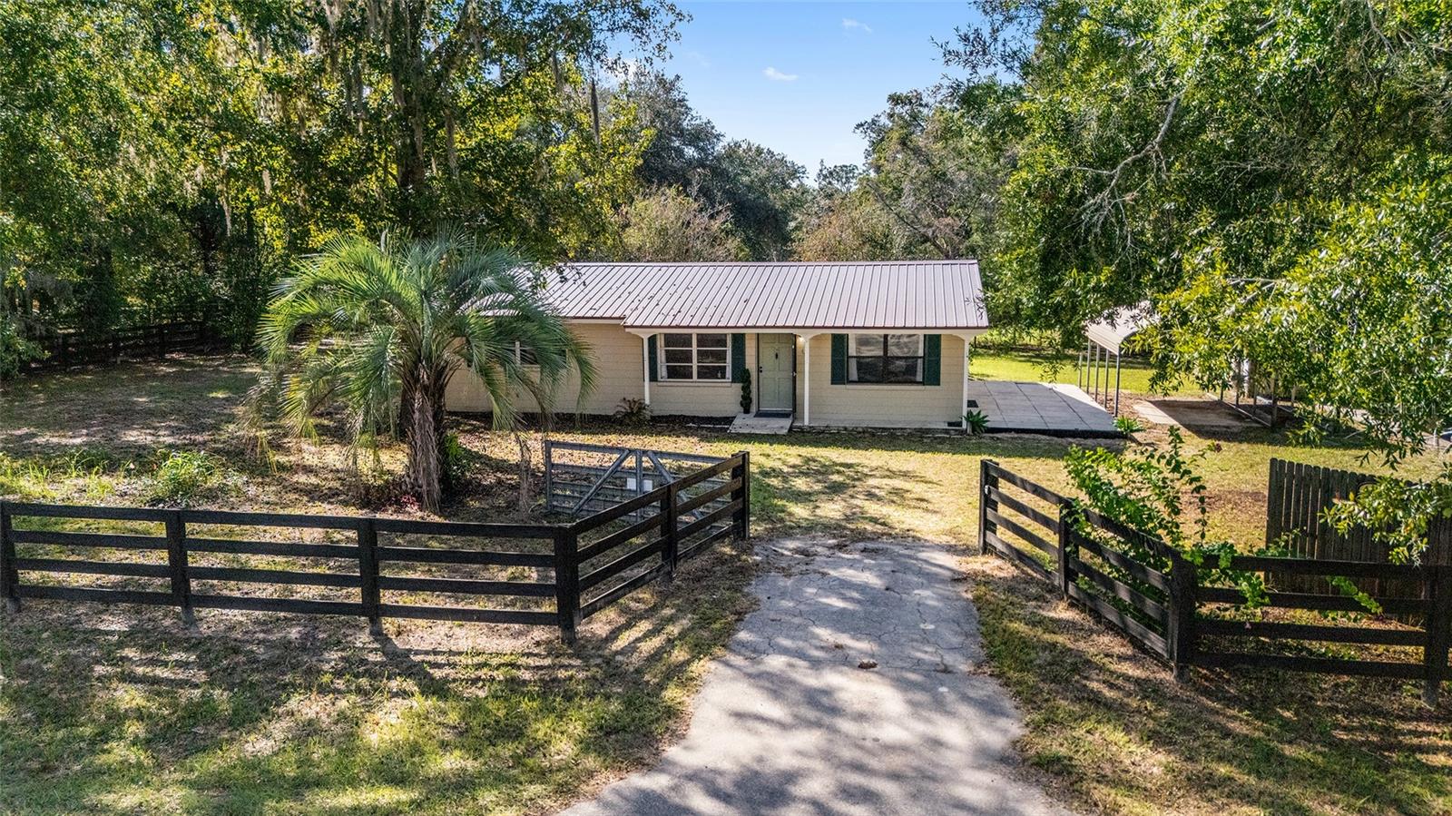 Beautifully updated and offering the rare option to expand with an adjoining horse-ready double lot next door, this 3BR/1BA, ˜1,469-sf concrete block home sits on a paved road on its own double-lot homesite (~0.48 ac) just ˜7 miles from the World Equestrian Center and ˜5 miles to the Rainbow River Headsprings. Notable upgrades include a metal roof, newer HVAC & water heater, brand-new kitchen appliances, all-new LVP flooring, fresh interior paint, and new four-board perimeter fencing. Mature shade trees frame the property, and daily function shines with two covered carports plus a substantial 16'×24' powered workshop (some exterior wood repair needed). Quiet, convenient location with easy access to Ocala, Dunnellon, WEC, HITS, and Rainbow Springs recreation. OPTIONAL EXPANSION For buyers seeking additional land, the adjoining double-lot is also for sale under Stellar MLS #GC534908 — fully fenced with horse stall, tack shed, and large double gate — and may be purchased separately or as a combined 1-acre package for a custom homesite, mini-farm or equestrian setup.