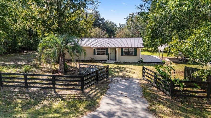 Beautifully updated and offering the rare option to expand with an adjoining horse-ready double lot next door, this 3BR/1BA, ˜1,469-sf concrete block home sits on a paved road on its own double-lot homesite (~0.48 ac) just ˜7 miles from the World Equestrian Center and ˜5 miles to the Rainbow River Headsprings. Notable upgrades include a metal roof, newer HVAC & water heater, brand-new kitchen appliances, all-new LVP flooring, fresh interior paint, and new four-board perimeter fencing. Mature shade trees frame the property, and daily function shines with two covered carports plus a substantial 16'×24' powered workshop (some exterior wood repair needed). Quiet, convenient location with easy access to Ocala, Dunnellon, WEC, HITS, and Rainbow Springs recreation. OPTIONAL EXPANSION For buyers seeking additional land, the adjoining double-lot is also for sale under Stellar MLS #GC534908 — fully fenced with horse stall, tack shed, and large double gate — and may be purchased separately or as a combined 1-acre package for a custom homesite, mini-farm or equestrian setup.