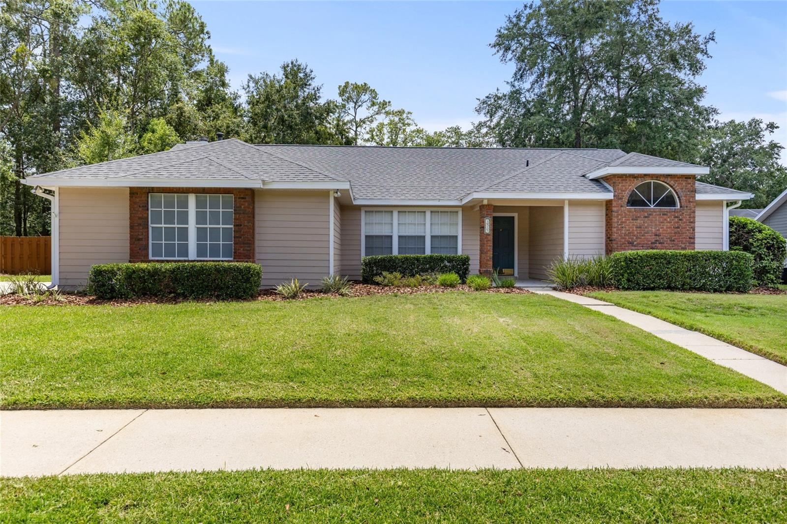 Beautiful pool home in Millhopper Station North! Freshly painted both inside and out, this home also features four spacious bedrooms with brand new carpet. This split floorplan gives everyone the feeling of privacy. The kitchen is fully equipped with refrigerator, range, dishwasher and microwave. There is beautiful wood cabinetry and granite countertops. The open floor plan features a family room with fireplace, living room and a separate dining area. Overlooking a serene pond with mature landscaping, the fully fenced backyard is a true oasis. Enjoy your solar heated pool with newer solar panels! (Two years old) The covered area is perfect for grilling and relaxing. Roof was replaced in 2019. This turnkey property is ready for it's new owner! Schedule your showing today!