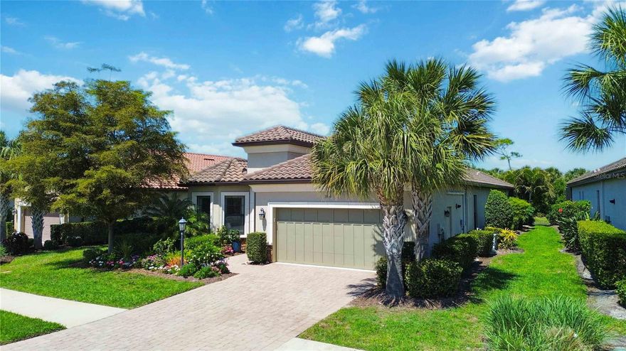 Discover coastal-inspired living at its finest in this exquisite lakefront home nestled within **Bayside**, an exclusive Taylor Morrison-built community of just 49 meticulously landscaped, maintenance-free residences. As you step inside, your eyes are immediately drawn through the expansive great room to breathtaking water views that capture the essence of waterfront living. The great room offers generous space for both elegant entertaining and relaxed everyday enjoyment, enhanced by tray ceilings and elegant crown molding—among the many thoughtful upgrades found throughout the home. The gourmet kitchen is a standout, featuring quartz countertops, a large closet pantry, premium GE Monogram appliances, an LG refrigerator, and a spacious island with seating that opens to a bright breakfast area. This space overlooks the lanai and pool, creating a seamless indoor-outdoor flow. Outside, the lanai is truly exceptional—an entertainer’s dream with a fully equipped outdoor kitchen, a cozy gas fireplace, both covered and open seating areas, and a sparkling saltwater pool and spa with gas heater. All of this is beautifully framed by a brand-new 2025 panoramic screen enclosure, offering sweeping views of the lake and abundant wildlife. The primary suite is a private retreat with stunning lake views with a luxurious bath featuring a spacious walk-in shower and a full wall vanity with dual sinks. The expansive walk-in closet includes custom built-ins for maximum storage and organization. A thoughtful split-bedroom plan ensures privacy, with Bedroom 2 offering an ensuite bath, Bedroom 3 conveniently located near the main bath, and a spacious den/office providing flexible living options. Additional practical features include a well-appointed laundry room with ample cabinetry and a garage equipped with its own split HVAC system. Bayside residents enjoy exclusive access to a private waterfront park overlooking the Intracoastal Waterway, with panoramic views of Casey Key and spectacular sunsets. This open space includes a day dock, kayak and paddleboard launch, fire pit, and generous lawn area—perfect for relaxing or gathering with friends.  Located west of the trail with direct water access, this rare combination of lifestyle and location is nearly impossible to find. Homes like this don’t last long. Don’t let this one get away!