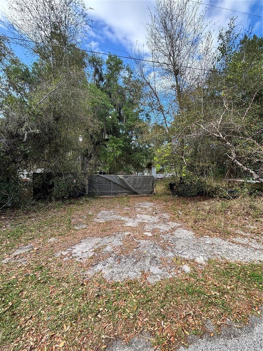 The Lot is 2.86 acres. The MH needs to be completely remodeled or removed or Build a Home. There is a Well on the property, Utility Pole also on the property..The property is 2 miles from The Villages and 10 miles from I-75