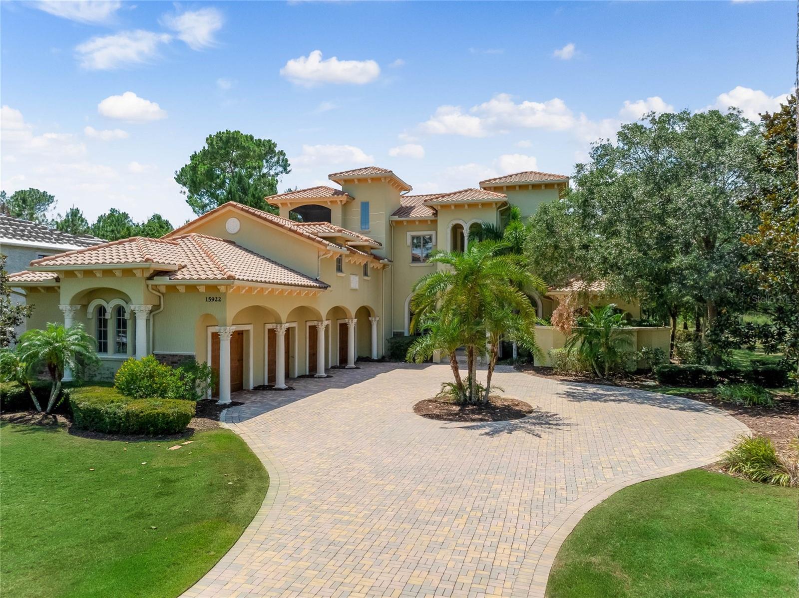 https://www.tourdrop.com/dtour/382861/Video -MUST SEE
Welcome to luxurious living in the highly desirable, gated community of Bella Collina. This magnificent custom-built estate spans an expansive 6,755 sq. ft. on a spacious 1.33-acre lot, surrounded by lush, mature landscaping. Offering 5 bedrooms and 7.5 bathrooms, this property epitomizes private, high-end living and entertaining. Upon entering, be captivated by the soaring cathedral ceilings, abundant natural light, and open-plan design, perfect for both intimate family gatherings and grandiose entertaining. Exquisite craftsmanship is evident throughout, with features such as a breathtaking fireplace, flowing travertine and hardwood flooring, coffered and tray ceilings, and custom crown molding. The palatial kitchen is a gourmet chef's dream, equipped with Viking appliances, granite countertops, and custom cabinetry. Seamlessly connected to the outdoor space, this floor plan offers an ideal setting for both entertaining and everyday living. The downstairs office boasts custom built-ins and elegant French double doors, providing a private retreat for work or study. The first-floor primary bedroom suite is a luxurious sanctuary, featuring a spacious bathroom with double vanities, a hot tub, a spa-like shower, and extensive walk-in custom closets. A well-designed 1st floor guest suite balances privacy and proximity, ensuring that the relative has both independence and easy access. The second floor includes 3 additional bedrooms, each with walk-in closets and en suite bathrooms, along with a large bonus room perfect for extra entertaining space. Step outside to discover the ultimate entertainment oasis. The expansive courtyard, custom pool, summer kitchen, and lanai create a resort-style ambiance, ideal for relaxation and outdoor gatherings. This exceptional property offers unparalleled luxury and privacy in Montverde.
Beyond the private retreat, residents can enjoy the array of amenities offered by The Club at Bella Collina, including two restaurants with indoor/outdoor patio dining, an outdoor pool complex, a fitness center with classes, a spa, a Har-Tru tennis complex, pickleball, a basketball court, and a Nick Faldo designed 18-hole Championship golf course. Schedule your private tour today and experience this haven of tranquility and elegance.