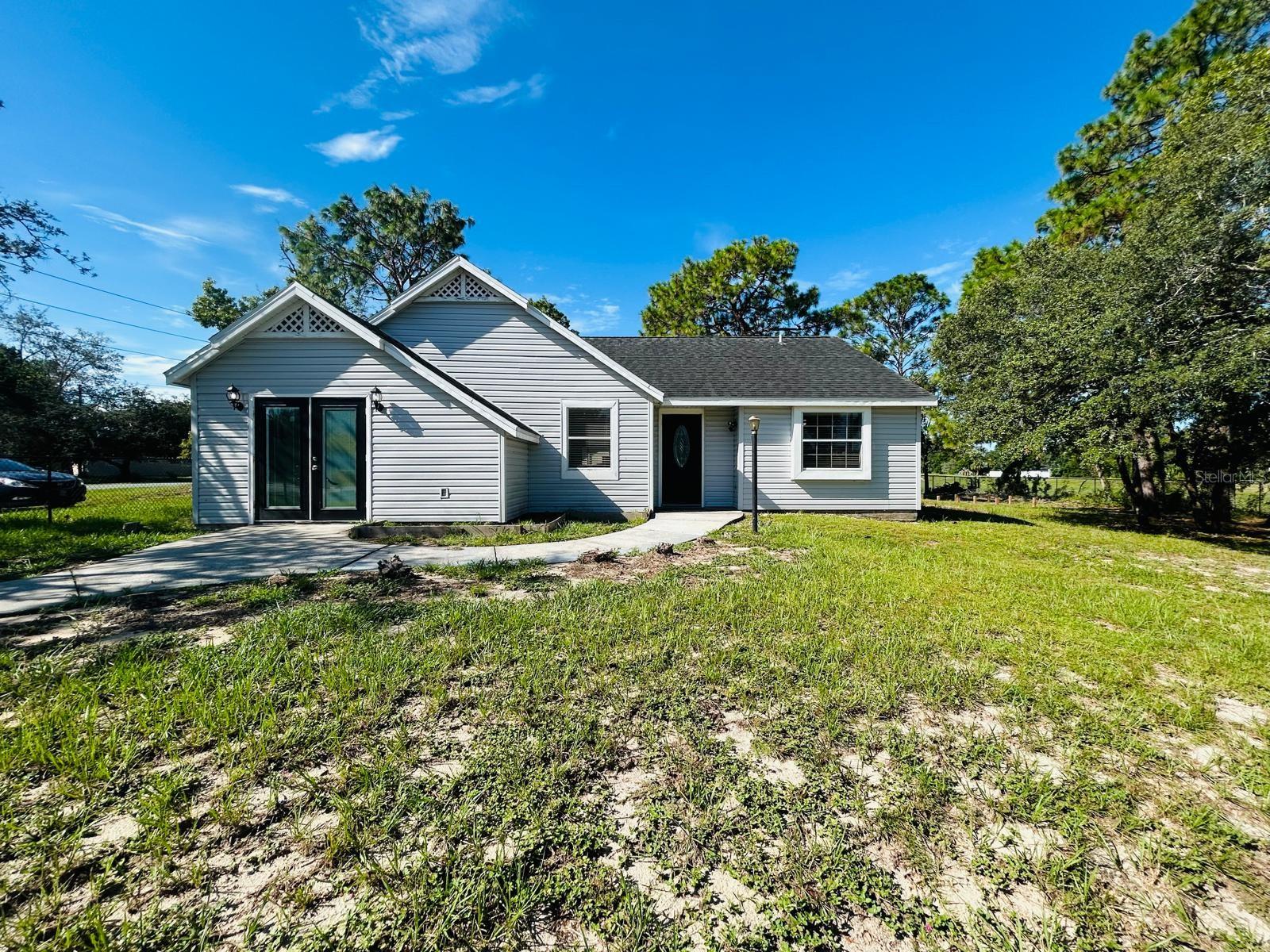 Spectacular move-in ready home in Spring Hill, FL!
Beautifully renovated 4-bedroom, 3-bath single-family home on a spacious corner lot. Features TWO master suites, one with a private exterior entrance and full bath—ideal for a home office, long-term guests, or additional income. Modern kitchen with solid wood cabinets, granite countertops, and included appliances. Recent upgrades: roof (2014), A/C (2021), new flooring, updated lighting, ceiling fans, outlets, and a fully fenced backyard. Enjoy the large screened-in lanai—perfect for relaxing or entertaining. No HOA and no CDD! Prime location near schools, shopping, medical centers, parks, and Weeki Wachee Springs. Perfect for families, remote work, or investment. Don’t miss this opportunity!