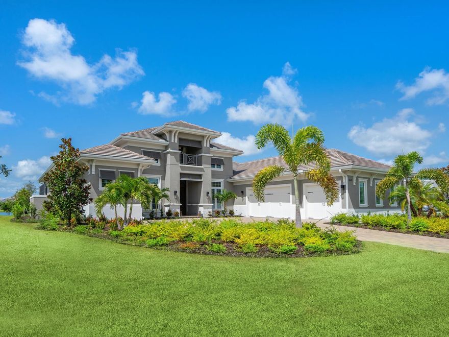 Step into a realm of elegance and comfort at 8541 Pavia Way, nestled in the Genoa section of The Lake Club. As you approach this magnificent home, you're greeted by a seamless blend of luxury and functionality. Engineered hardwood floors guide you through the expansive living spaces. The great room, with its inviting ambiance and impact glass windows, is filled with natural light, creating an atmosphere of warmth and tranquility. The wall of pocketing sliders creates an open indoor-outdoor living space. The kitchen boasts pristine white quartz countertops, a large floating island, and top-of-the-line KitchenAid appliances. The stainless steel five-burner cooktop and exhaust hood are complemented by a sleek subway tile backsplash, perfect for culinary enthusiasts. Adjacent to the kitchen, the breakfast area features a picturesque window that frames breathtaking water views, making every morning meal a serene experience. The formal dining room invites you to host unforgettable dinner parties under sophisticated ceiling treatments. Step into the study, where French doors provide a quiet retreat and offers versatility, serving as an additional living area or a private office. The bonus room comes equipped with a wet bar, sink, and refrigerator, ready for game nights or cozy gatherings. This room also has the potential to be transformed into a fourth bedroom, accommodating growing families or visiting guests. The primary suite is a sanctuary of luxury, featuring tray ceilings, ample walk-in closet space, tons of natural light and direct access to the lanai. The primary bath is an epitome of spa-like elegance, with a soaking tub, walk-in shower, dual vanities, a makeup vanity, and a private water closet. There are also two well-appointed guest suites complete with en-suite full baths. Outside, the paver lanai beckons you to unwind and enjoy the Southwest exposure and serene water views. The panoramic lanai screen ensures unobstructed views while motorized storm screens will soon be added in the lanai for enhanced protection and privacy. Dive into the saltwater pool, relax in the spa, or enjoy the soothing sounds of the spillover fountains. The lanai is plumbed for an outdoor kitchen, offering the potential for future enhancements. Additional features include a half bath that works as a pool bath, a three-car garage with a mini-split system, a new whole-home Generac generator, and plantation shutters adorning many rooms, adding a touch of classic charm. This home offers the perfect blend of luxury and functionality, creating an exceptional living experience. The Lake Club provides an array of amenities and a sense of community that enhances the experience of living in this exceptional residence. Residents can utilize the grand clubhouse with a restaurant and bar, two resort-style pools, a fitness center, a massage and skincare room, a gaming and lifestyle center, and various sports facilities. This location is surrounded by top-rated schools and is a short distance away from dining, entertainment, and shopping, including the popular UTC Mall, Lakewood Ranch Main Street, Waterside Place, and more.