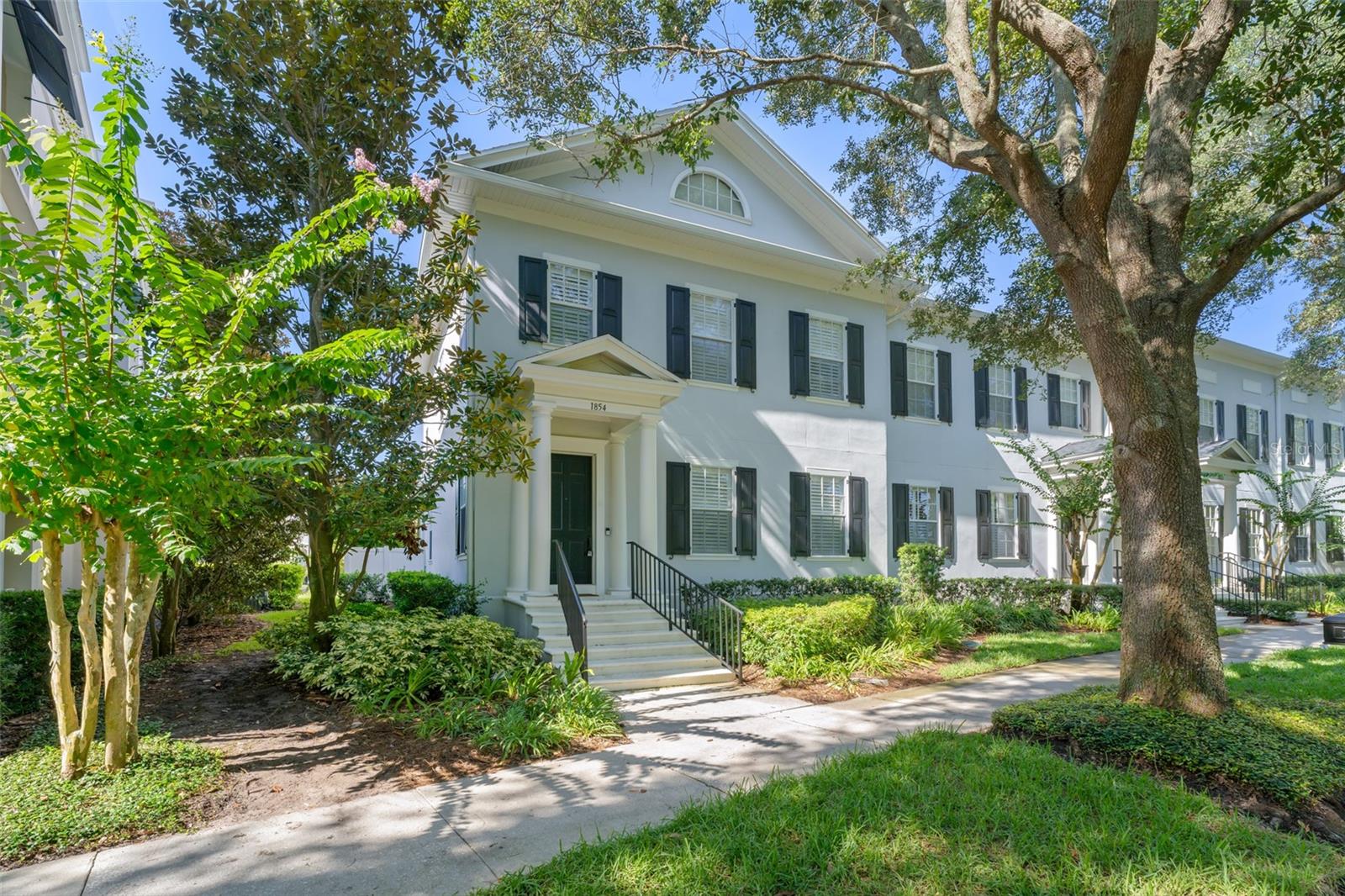 Welcome to 1854 Meeting Place, a distinguished corner-unit townhome overlooking serene park views in the heart of Baldwin Park—one of Orlando’s most sought-after and walkable master-planned communities. Spanning 2,667 square feet, this elegant residence offers 3 spacious bedrooms, 2.5 bathrooms, and a generous second-floor loft, perfectly suited for a home office, media retreat, or additional guest space. Ideally located just steps from the Baldwin Park Village Center, Grace Hopper Hall, Corrine Commons, Publix, and Lake Baldwin Park, this home places you within effortless reach of top-rated dining, boutique shopping, lakeside trails, and everyday conveniences—all within one of the most thoughtfully designed neighborhoods in Central Florida. Zoned for exceptional schools including Baldwin Park Elementary, Glenridge Middle, and Winter Park High, this property also offers quick access to Winter Park, Audubon Park, and Downtown Orlando. Inside, you’ll be greeted by a sunlit open layout with soaring ceilings and refined details, including a spacious living room with custom built-ins and a gas fireplace, which flows seamlessly into a designer kitchen and family room enhanced by a striking brick accent wall, granite countertops, stainless steel appliances, a gas stove, and upgraded cabinetry. The first-floor primary suite serves as a true private retreat, appointed with crown molding and a spa-like en-suite showcasing natural stone finishes curated by designer Wendy Kensler, a dual vanity, jetted soaking tub, and a large walk-in closet. Upstairs, two additional bedrooms provide ample space and storage, complemented by a full bath and an oversized loft ideal for flexible living. Outside, the private paver courtyard is surrounded by lush landscaping and enclosed with a privacy fence—perfect for entertaining, dining al fresco, or simply unwinding in peace. The oversized two-car garage offers matted flooring and built-in storage, rounding out this home's perfect balance of beauty and functionality. As a Baldwin Park resident, you’ll enjoy exclusive access to three resort-style community pools, two modern fitness centers, multiple parks and playgrounds, and miles of picturesque walking and biking trails along Lake Baldwin. With its unmatched location, refined interior features, and access to a vibrant, amenity-rich neighborhood, this townhome offers an extraordinary opportunity to enjoy luxury living in one of Orlando’s most desirable enclaves—schedule your private tour today.