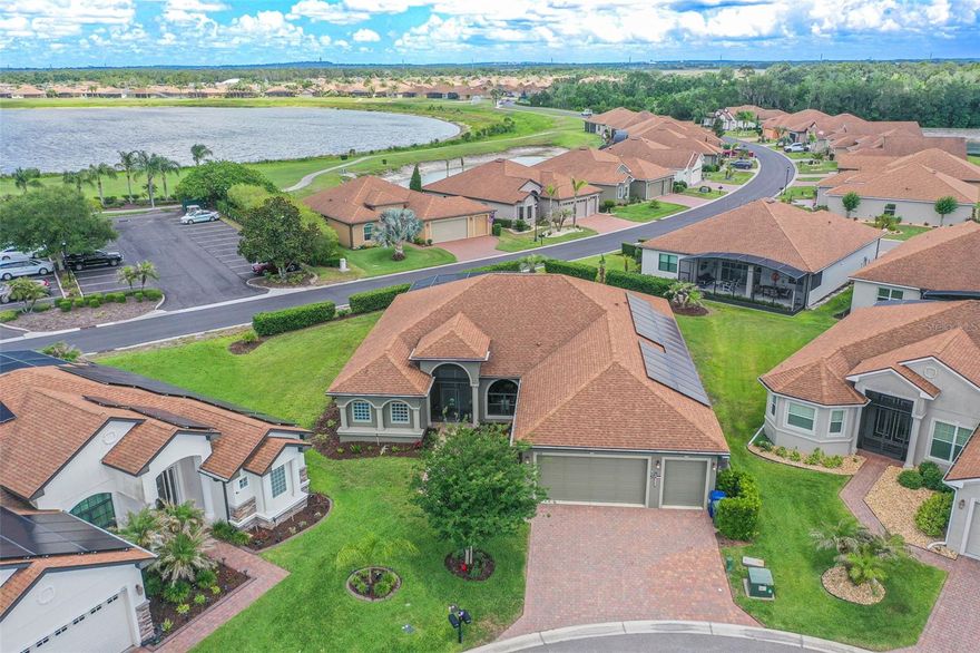 Discover exceptional luxury living in the highly sought-after gated 55+ golf community of Lake Ashton, offering 24-hour security and an incredible resort-style lifestyle. This stunning Ashton floor plan features approximately 2,606 square feet of beautifully designed living space with 3 bedrooms, 2 full bathrooms, a den, a versatile flex room, and a SPACIOUS 2 CAR AND A GOLF CART GARAGE that also can hold up to 2 golf carts, creating the perfect balance of comfort, functionality, and elegant entertaining space.
From the moment you step inside, you’ll appreciate the soaring cathedral ceilings, elegant tray ceiling accents, recessed lighting, crown molding, beautifully updated fixtures, and the seamless blend of laminate flooring and ceramic tile throughout. Designed for the culinary enthusiast, the GOURMET KITCHEN showcases soft-close solid wood 42-inch cabinetry with crown molding, luxurious granite countertops, stainless steel appliances including a Bosch dishwasher and Whirlpool refrigerator, a beautiful vented hood, double convection ovens, microwave, and abundant prep and storage space.

One of the standout features of this remarkable home is the FULLY PAID OFF SOLAR PANEL SYSTEM with transferable warranty, offering incredible energy efficiency and long-term savings. The home also includes a whole-house generator providing peace of mind and uninterrupted comfort during outages. The oversized garage offers additional storage, golf cart parking, a golf cart charger, and the SELLER IS INCLUDING THE GOLF CART WITH THE SALE for added convenience.
The luxurious primary suite offers a true spa-like retreat featuring custom closets, room-darkening shades, a relaxing soaking tub, an oversized walk-in shower, and a private sauna. Additional custom built-ins throughout the home provide exceptional organization and functionality.
Step outside to the breathtaking oversized screened lanai designed for year-round Florida living and entertaining. This incredible outdoor space features remote-control privacy roller shades, a fully equipped outdoor kitchen with stainless steel grill, kegerator, wine fridge, barbecue area, and the showstopping Veranda 10-person hybrid swim spa perfect for relaxation or exercise.

Additional upgrades include beautifully ENHANCED LANDSCAPING, UPDATED IRRIGATION SYSTEM, abundant storage throughout, and NEGOTIABLE FURNISHINGS allowing buyers the opportunity for a truly move-in-ready experience. Conveniently located near golf courses, shopping, dining, medical facilities, major roadways, nearby lakes, and attractions including LEGOLAND Florida Resort, this extraordinary home offers luxury, efficiency, security, and the ultimate Florida lifestyle all in one exceptional package.
