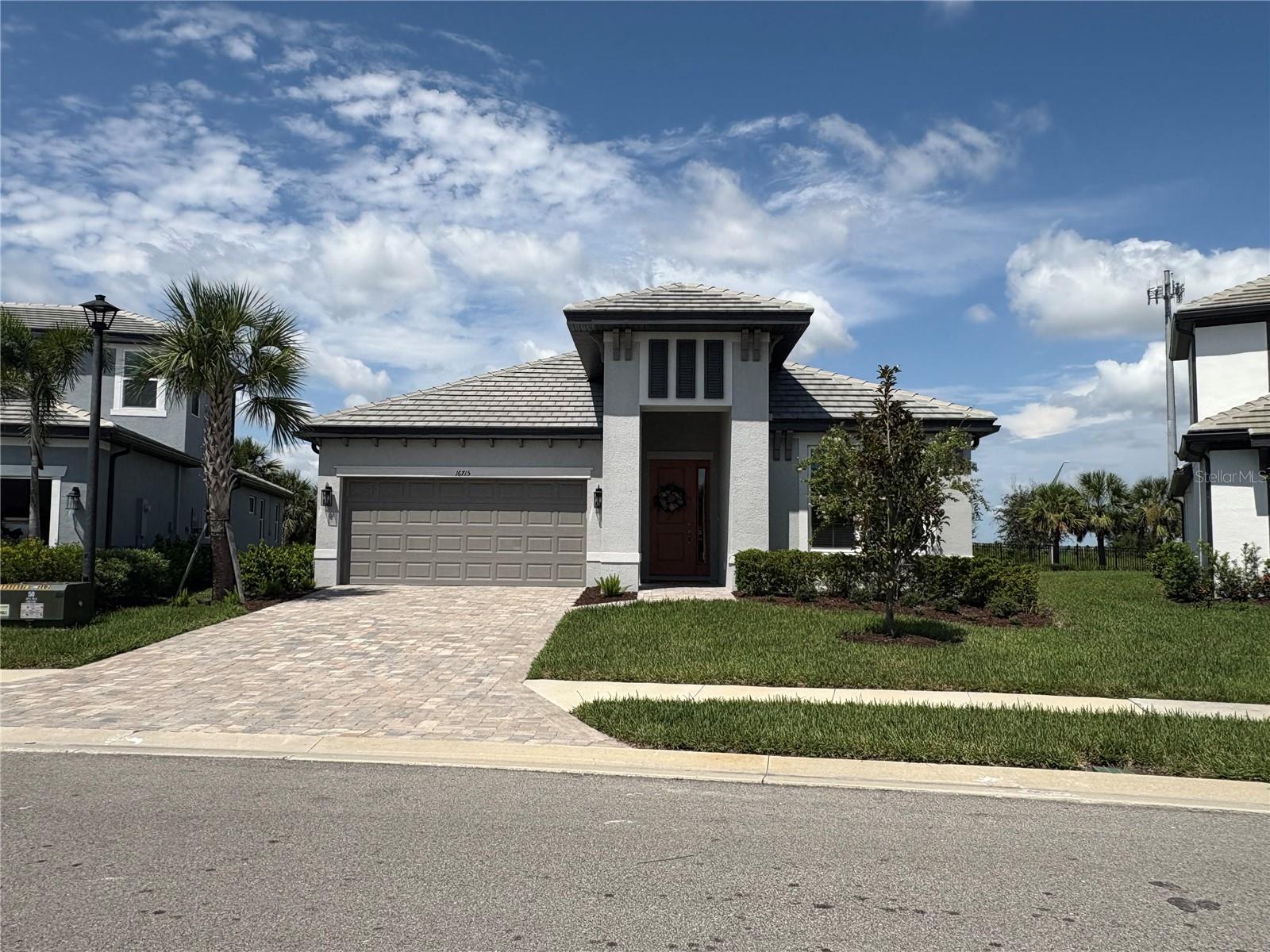 This beautifully designed unfurnished home offers 1,761 square feet of living space perfect for both relaxing and entertaining. From the moment you walk in, you'll notice elegant details such as trey ceilings in the great room and master bedroom, crown molding throughout the main living areas along with designer light fixtures and ceiling fans. (the dining room fixture does not stay with the property and will be replaced).There is solid flooring throughout. The open-concept kitchen is a chef’s dream, featuring stainless steel appliances, a gas range, subway tile backsplash, cabinetry topped with crown molding and a pantry. It seamlessly overlooks a bright and airy great room, perfect for gatherings. Step through sliding glass doors to a paver covered lanai with outdoor built-in grill that opens to a spacious backyard—ideal for enjoying Florida’s outdoor lifestyle. The split floorplan offers privacy to the primary bedroom with a lovely en-suite bathroom complete with dual sinks and a beautifully tiled walk-in shower. The guest bedroom is a nice size, and the guest bathroom also offers modern comfort with double sinks and a sleek shower design. Located in the highly sought-after Sweetwater community residents enjoy access to resort-style amenities, including a heated pool, clubhouse, fitness center, pickleball and basketball courts, and a playground.