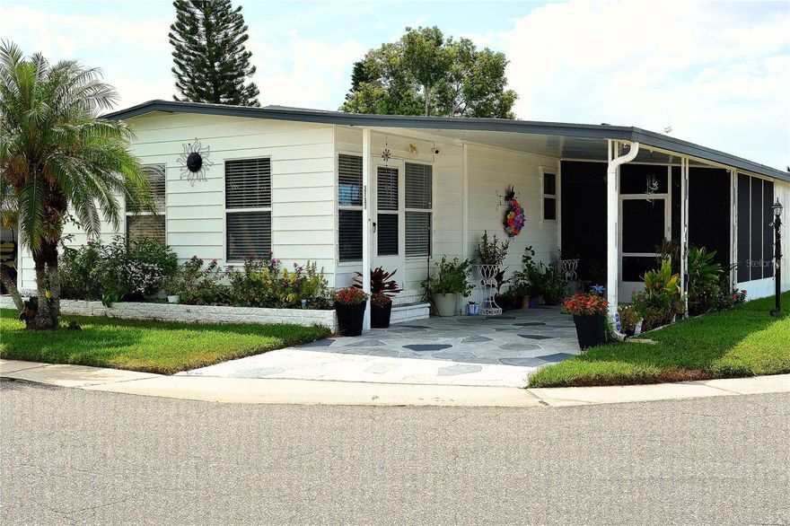 Presenting your new home in the desirable Tanglewood Mobile Village Condominium, a well-maintained 55+ community in Holiday, Florida. This spacious double-wide manufactured home offers 2 bedrooms, 2 bathrooms, and a fully enclosed Florida room, perfectly situated on a corner lot with no CDD fees, no flood zone, and a peaceful pond view.
Step inside and immediately appreciate the open floor plan, designed for both comfort and style. The layout flows seamlessly through the window-enclosed Florida room, a fully renovated kitchen, and updated bathrooms and bedrooms.
The kitchen is a true showpiece, showcasing white shaker-style cabinetry, granite countertops, and a spacious island with breakfast bar seating. The adjoining dining room features matching cabinetry with a built-in buffet/bar, perfect for entertaining.
The spacious living room invites gatherings and opens to the Florida room through double sliding glass doors, enhancing the home’s bright and airy feel. Flooring includes wide-plank luxury vinyl in the main living areas for a cohesive design and porcelain tile in the bathrooms for durability and elegance.
The primary suite easily accommodates king-size furnishings and offers a private bathroom, walk-in closet, and ceiling fan. The remodeled en-suite bath features a step-in shower with marble-style tile walls, contrasting dark shower floor, and a granite-topped vanity with matching cabinetry, creating a refined, spa-like atmosphere.
The second bedroom includes a custom built-in shelving and desk area, closet, and ceiling fan, making it ideal for guests or a home office. The guest bathroom is equally impressive with a beautifully tiled shower, updated vanity with quartz countertop, and newer fixtures.
Recent updates provide peace of mind, including: New A/C (2021), Durable metal roof (2005),Updated electrical panel (2004),Crawl space improvements (2024), and updated windows.
Exterior highlights include a covered carport, stamped and painted concrete driveway, storage shed with washer and dryer, workshop with shelving, screened porch, and a backyard patio overlooking the pond. Storm shutters provide added window protection.
This property is truly move-in ready. The welcoming 55+ community features a heated pool, shuffleboard, and clubhouse with a variety of social activities, all included in the low $148 monthly HOA fee. Ideally located near beaches, shopping, dining, medical facilities, and local attractions.
Schedule your private showing today!