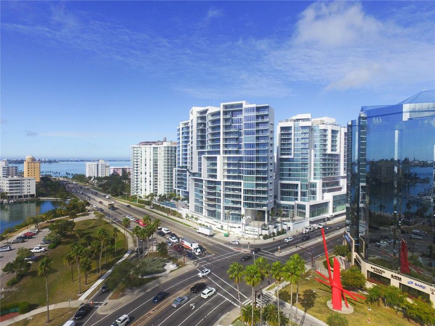 This exceptional 3-bedroom, 2.5-bath residence offers one of the most breathtaking views available at VUE Sarasota Bay!  Paired with premium designer-level finishes throughout, this home delivers unmatched value for those seeking sophisticated downtown waterfront living.  Situated to capture sweeping vistas of Marina Jacks and Sarasota Bay, this modern residence showcases an open, light-filled floor plan enhanced by soaring ceilings and dramatic 10’ floor-to-ceiling impact glass.  Contemporary details include LED lighting, designer fixtures, motorized shades, and rich tile flooring. The gourmet kitchen is a showpiece, featuring a large waterfall edge island overlooking the living room/dining room, induction cooktop, and top-tier stainless appliances.  The spacious primary suite is a private retreat with dazzling water views, an oversized spa-like bath with dual vanities, soaking tub, and large walk-in shower.  The guest suite also includes an ensuite bath, while the additional den provides flexible space for work or relaxation (easily converted into a third bedroom with the simple addition of a door to the existing closet).  Step outside to the expansive 10’x28’ terrace and enjoy nightly sunsets—an ever-changing canvas over the bay.  Enjoy an array of world-class amenities, including a resort-style heated pool and spa, fitness center, elegant club lounge, concierge services, valet parking, private climate-controlled storage, dog park with grooming station, and exclusive residents’ social spaces. Your private-access elevator opens directly into your personal foyer, creating an elevated sense of arrival.  Perfectly positioned in the heart of downtown Sarasota, VUE places you steps from theaters, opera, fine dining, shopping, the Bayfront, and neighboring luxury hotels including The Westin and The Ritz-Carlton. From morning walks over the Ringling Bridge to evenings at St. Armands Circle or the sandy shores of Lido Key, this location is truly unmatched.  Experience the best of Sarasota’s waterfront lifestyle in a residence that embodies luxury, comfort, and iconic city-and-bay views with a premier location.