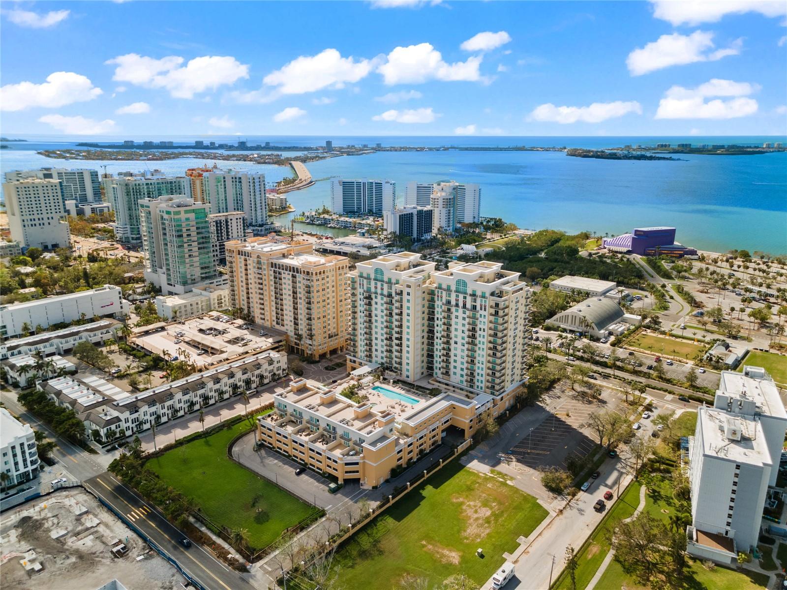 Welcome to Alinari at Rosemary Place, a unique, luxury condominium development set on eleven acres in Downtown Sarasota. Experience this exclusive blend of privacy, space and style in this unique multilevel end-unit remodeled townhome with your own private entrance. Enjoy 1,734 sq. ft. of remodeled interior living space and your very own private 942 sq. ft. Rooftop Deck with sweeping views of Sarasota Bay, the Sarasota city skyline, resort-style pool and spa deck, and unforgettable sunsets. One of only 6 private townhomes located just off the pool—and the only one currently available—this residence is truly a rare offering. Upon entering at your very own private entrance, cross the threshold and enjoy soaring 18-foot ceilings showcasing ample windows that create an expansive, light-filled interior that seamlessly blends with the outdoor scenery with high-end finishes, including custom Venetian plaster walls, designer lighting, custom plantation shutters and freshly painted interior. The kitchen is well-appointed with quartz countertops, large bar counter, stainless steel appliances, custom designer soft close cabinetry with ample storage space and an oversized pantry. The adjacent spacious dining area has ample room for 6-8 and flows seamlessly into the living room creating the perfect open-concept floor plan for relaxing and entertaining with friends. The versatile 2nd bedroom/den with an adjacent full bath was previously used as both by the current owner. See images of the custom Murphy Bed with storage. Town records classify unit as a 1BR, but it lives comfortably as a 2BR thanks to the sleek sliding partition door. Open the French doors to a spacious oversized terrace (approx. 642 sq. ft.) which is one of 3 private outdoor spaces. Upstairs, the expansive Primary Suite features its own private balcony, walk-in closet and large en-suite bath with dual sinks, soaking tub, large separate walk-in shower and linen closet. Continue to your very own Private Rooftop Terrace Retreat, which spans the full length of the residence and sets the stage for true luxury overlooking the city skyline and Sarasota Bay making it an inviting space for relaxation, al fresco dining or entertaining. Additional highlights include an oversized laundry room w/built-in cabinetry, retractable screens for airflow throughout, generous storage, two AC units, custom window treatments, upgraded ceiling fans, custom stainless stair railing & beautiful tile floors. Alinari residents enjoy 24-hour concierge and security with onsite management staff, an 80’ heated lap pool and spa, fitness center, private cinema, outdoor grilling, business center, club room with bar and entertaining kitchen, social and tea rooms, wine cellar with personal locker (a favorite spot for casual wine gatherings), billiards, three guest suites to accommodate additional overnight guests, a large dog park, designated garage parking, a climate controlled storage unit, indoor bicycle storage and an active social committee that plans engaging events throughout the year Alinari residents can rest assured as the building was built at 16’ feet above sea level and is located in an X flood zone and has passed its structural survey with no assessments coming up. Total indoor and outdoor living space: 3,389 sq. ft. all just minutes from Sarasota Bay, Van Wezel, St. Armands Circle, Lido Beach, Sarasota’s vibrant downtown shopping, fine dining, marinas, and expansive arts and cultural offerings.