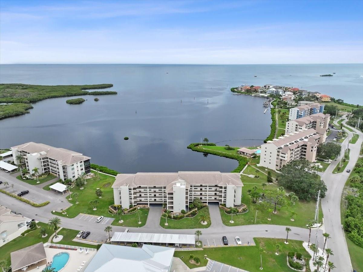 Rarely does a home come along where the view is as unforgettable as the lifestyle—this highly sought-after Gulf-front end-unit in Building 9 is one of them. Evenings here are defined by glowing West-facing sunsets that spill across the horizon, dolphins playing offshore, and sailboats drifting by. From your lanai, living room, or primary suite, the Gulf isn’t just a view—it’s the heart of everyday living. And with this condo, beauty is matched by peace of mind. The Milestone Inspection and SIRS are complete, the association reports no upcoming assessments, and the HOA is fully funded and well managed. The community is secured by a 24/7 guard gate, the building is elevated, with residences set above the parking level to help minimize typical flood concerns and this unit is fitted with new hurricane-impact windows and doors (24k) —still under warranty—for added confidence, energy efficiency and sound proofing. Additionally there is new plantation shutters throughout. Parking is another standout: your premium garage space—nearly enclosed and located at the base of the stairs leading to your unit—offers unmatched convenience, with your car, private storage locker, and bike rack all together. An additional parking space is also included, and the building features an elevator for ease. Beyond your door, Sand Pebble Pointe feels like a private resort. Swim year-round in the 2 heated pools with grilling areas, stroll the waterfront boardwalk, or practice on the putting green before dinner. The clubhouse offers a fitness center, library, card room, and social spaces that owners can even reserve for private gatherings at no cost. Neighbors gather for tennis and pickleball, while those who love the water enjoy a private community boat ramp, along with options for boat docks and RV/boat storage (when available) and kayak storage for an additional fee when space allows. With direct open-Gulf access and no bridges, weekends can mean island hopping to Anclote or Three Rooker—or simply drifting beneath a painted sunset sky. Inside, the property reflects a comprehensive remodel designed for both style and ease. Every detail was addressed—from lighting and fixtures to finishes, and even the plumbing. The kitchen pairs granite counters with shaker cabinetry and stainless appliances, opening seamlessly to dining and living spaces framed by Gulf views. Luxury vinyl flooring runs throughout for a clean, low-maintenance look. The primary suite is a true retreat, offering lanai access, Gulf views, a spacious walk-in closet, and a modern double-vanity bath. Guests enjoy their own private wing thanks to the split-bedroom layout. Ownership here also means carefree living, with the monthly HOA fee covering cable and high-speed internet (with premium channels), sewer, trash, exterior maintenance, and building insurance—allowing you to spend more time enjoying the lifestyle and less time worrying about the details. Beyond the gates, you’re less than two miles from numerous waterfront restaurants, along with a public boat ramp and bait shop. The nearby Port Richey Marina offers wet slips, fuel, daily boat rentals, and is home to Freedom Boat Club—perfect for enjoying the boating lifestyle without the maintenance. Priced well below recent sales of similar units, the value here is as clear as the water views. This is more than a condo—it’s a front-row seat to sunsets, a community that feels like vacation, and a home crafted for comfort, confidence, and coastal living.