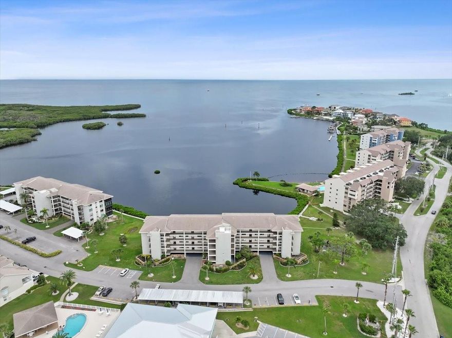Rarely does a home come along where the view is as unforgettable as the lifestyle—this highly sought-after Gulf-front end-unit in Building 9 is one of them. Evenings here are defined by glowing West-facing sunsets that spill across the horizon, dolphins playing offshore, and sailboats drifting by. From your lanai, living room, or primary suite, the Gulf isn’t just a view—it’s the heart of everyday living. And with this condo, beauty is matched by peace of mind. The Milestone Inspection and SIRS are complete, the association reports no upcoming assessments, and the HOA is fully funded. The community is secured by a 24/7 guard gate, the building is elevated, with residences set above the parking level to help minimize typical flood concerns and this unit is fitted with new hurricane-impact windows and doors (24k) —still under warranty—for added confidence, energy efficiency and sound proofing. Sold partially furnished (if desired) and there are new plantation shutters throughout. Parking is another standout: your premium garage space—nearly enclosed and located at the base of the stairs leading to your unit—offers unmatched convenience, with your car, private storage locker, and bike rack all together. An additional parking space is also included, and the building features an elevator. Beyond your door, Sand Pebble Pointe feels like a private resort. Swim year-round in the 2 heated pools with grilling areas, stroll the waterfront boardwalk, or practice on the putting green. The clubhouse offers a fitness center, library, card room, and social spaces that owners can even reserve for private gatherings at no cost. Neighbors gather for tennis and pickleball, while those who love the water enjoy a private community boat ramp, along with options for boat docks and RV/boat storage (when available) and kayak storage for an additional fee when space allows. With direct open-Gulf access and no bridges, weekends can mean island hopping to Anclote or Three Rooker—or simply drifting beneath a painted sunset sky. Inside, the property reflects a comprehensive remodel designed for both style and ease. Every detail was addressed—from lighting and fixtures to finishes, and even the plumbing. The kitchen pairs granite counters with shaker cabinetry and stainless appliances, opening seamlessly to dining and living spaces framed by Gulf views. Luxury vinyl flooring runs throughout for a clean, low-maintenance look. The primary suite is a true retreat, offering lanai access, Gulf views, a spacious walk-in closet, and a modern double-vanity bath. Guests enjoy their own private wing thanks to the split-bedroom layout. Ownership here also means carefree living, with the monthly HOA fee covering cable and high-speed internet (with premium channels), sewer, trash, exterior maintenance, and building insurance—allowing you to spend more time enjoying the lifestyle and less time worrying about the details. Beyond the gates, you’re less than two miles from numerous waterfront restaurants, along with a public boat ramp and bait shop. The nearby Port Richey Marina offers wet slips, fuel, daily boat rentals, and is home to Freedom Boat Club—perfect for enjoying the boating lifestyle without the maintenance. Priced well below recent sales of similar units, the value here is as clear as the water views. This is more than a condo—it’s a front-row seat to sunsets, a community that feels like vacation, and a home crafted for comfort, confidence, and coastal living.