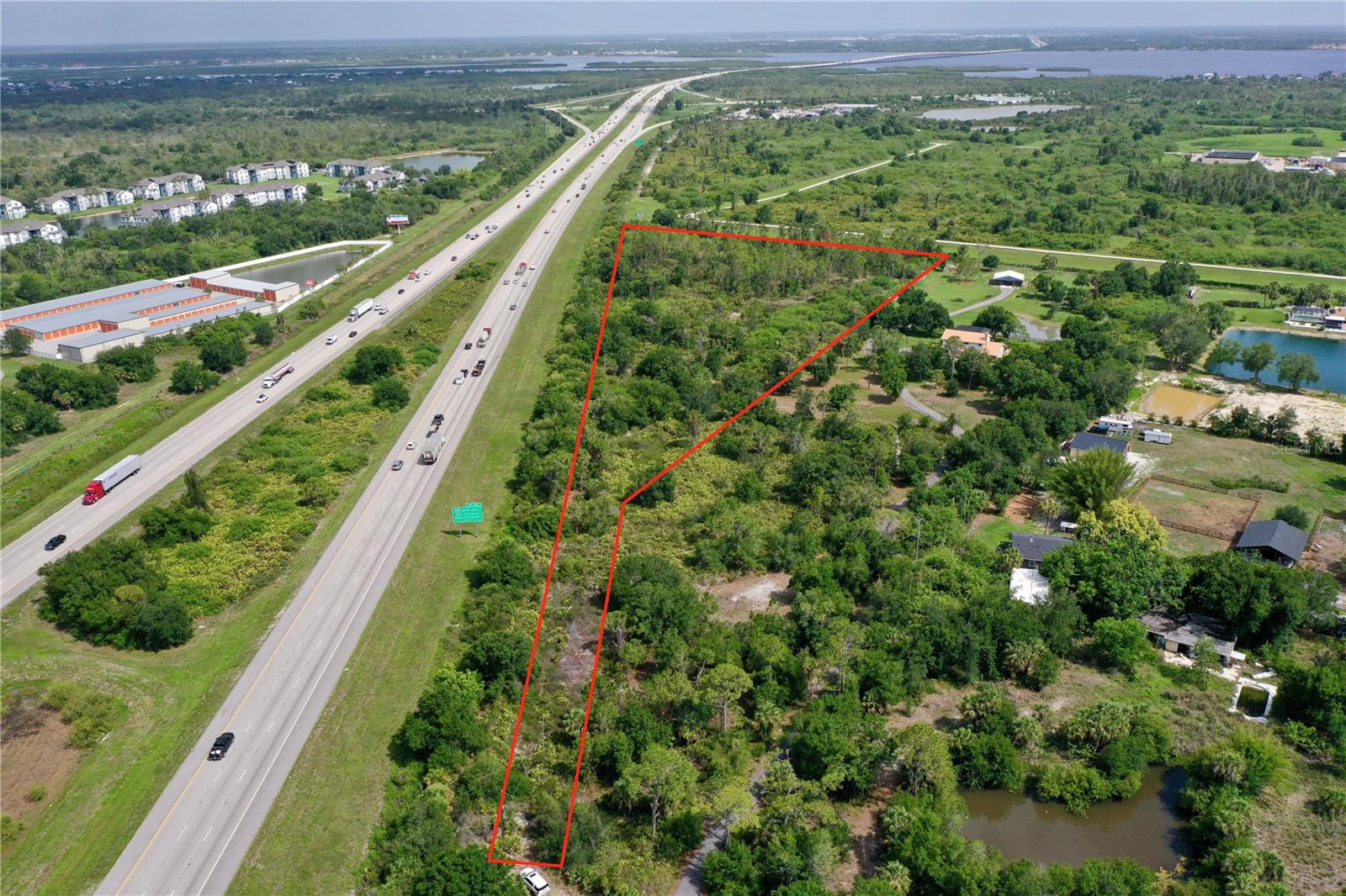 7.59 Acres of residentially zoned (RE1) land located in Suncoast Estates—an ideal spot to build your custom dream home and enjoy the Florida lifestyle with no HOA fees or deed restrictions. Situated at the end of the street, this property offers added privacy and a peaceful setting. Conveniently located off Kings Highway, you're just minutes away from a wide variety of shopping, dining, and entertainment options. For boating enthusiasts, Charlotte Harbor and public boat ramps are less than a 10-minute drive, allowing you to enjoy the water while still living on spacious acreage. Many new homes are being built in the surrounding area, making this a great opportunity for investors to add a prime piece of land to their portfolio. According to Charlotte County GIS, the property is not in a Scrub Jay mitigation area. Commuting is easy with both US-41 and I-75 just 5 minutes away, offering quick access to nearby areas and attractions. The property is also close to the Sunseeker Resort, Downtown Punta Gorda, Port Charlotte Town Center, Charlotte Sports Park (home of the Tampa Bay Rays Spring Training), and numerous restaurants and golf courses—enough to play a different one each day of the week. Best of all, you're only 30 minutes from some of Southwest Florida’s most beautiful beaches. Don’t miss your chance to own this piece of acreage in a growing area—schedule your showing today!