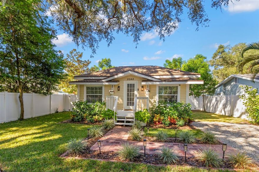 NO HOA AND NON-FLOOD ZONE! HUGE STORAGE SHED INCLUDED! LOCATED ONE BLOCK FROM DUNEDIN and only 5 MINUTES TO VIBRANT DOWNTOWN DUNEDIN, this FULLY UPGRADED 3-bedroom / 2-bath 1930's BUNGALOW perfectly blends HISTORIC CHARM with modern comforts. Tucked quietly at the end of the street, this home’s curb appeal shines with a BRICK PAVERED WALKWAY accented by landscape lighting, and a spacious front yard with classic wrought-iron fence separating the front yard from the street.  Mature shade trees with vines create a storybook setting with room for outdoor seating and even a tree swing. A welcoming front porch and decorative glass front door set the tone. Inside, an inviting OPEN FLOOR PLAN filled with warmth and character showcases gorgeous TEXTURED WIDE-PLANK LAMINATE WOOD FLOORING throughout the main living areas. Timeless WOOD-TRIMMED WINDOW CASINGS on all windows add character and window blinds are installed throughout. The UPGRADED EAT-IN KITCHEN features MULTI-LEVEL WOOD CABINETRY, STAINLESS STEEL APPLIANCES and a pantry. The primary bedroom suite includes a BUILT-IN CLOSET SYSTEM with drawers and shelves and a modern EN SUITE BATH with a tiled step-in shower. Two additional bedrooms share a beautifully updated full bath with DECORATIVE WAINSCOTING, a tub/shower combo, and linen storage. The 3rd bedroom stands out with CROWN MOLDING, WAINSCOTING and a COZY WINDOW BENCH making the perfect reading nook! EVERY CLOSET THROUGHOUT THE HOME HAS BEEN THOUGHTFULLY CUSTOMIZED WITH BUILT-IN SHELVING for maximum organization. The OVERSIZED INTERIOR LAUNDRY ROOM offers extra space that can EASILY DOUBLE AS AN OFFICE/DEN, extra storage or additional closet. Step outside to a VINYL FENCED PRIVATE BACKYARD OASIS partially XERISCAPED with LUSH LANDSCAPING, BRICK PAVERED WALKWAYS, wooden benches, planters, and a huge detached storage shed with tall ceilings — perfect for bikes, tools, hobbies, or recreational gear. ADDITIONAL UPGRADES INCLUDE: NEW VINYL FENCE (2024), NEWER DOUBLE PANE WINDOWS, NEWER HVAC & ALL NEW DUCTWORK (2020), NEW TANKLESS WATER HEATER, NEW STAINLESS DISHWASHER & FRIDGE (2023), CUSTOM BUILT SHELVES IN GUEST BEDROOM CLOSETS, LINEN CLOSETS AND PANTRY, NEW SUBFLOOR IN PRIMARY SUITE, NEW TOILETS IN BATHROOMS, RESEALED TUB IN GUEST BATH, SIX-PANEL INTERIOR DOORS THROUGHOUT, RECESSED LIGHTING, WINDOW BLINDS THROUGHOUT, NEW PLUSH CARPETS IN BEDROOMS, NEW TILE FLOOR IN LAUNDRY ROOM and ROOF ONLY 6 YEARS OLD (2019)! TRANSFERRABLE TERMITE BOND WITH TERMINIX INCLUDED! Enjoy the Florida lifestyle JUST A COUPLE MINUTES FROM THE PINELLAS TRAIL and the WATERFRONT EDGEWATER DRIVE for DOLPHIN WATCHING and BREATHTAKING SUNSETS! 5 MINUTES TO DOWNTOWN DUNEDIN to enjoy SHOPS, RESTAURANTS and EVENTS! 15 MINUTES TO THE BEAUTIFUL GULF BEACHES OF HONEYMOON ISLAND AND CLEARWATER BEACH! This home checks every box — location, charm, upgrades, and outdoor living — all wrapped in the heart of Dunedin’s coastal community. Welcome home!