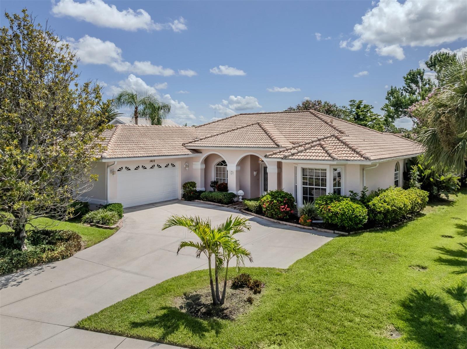This 2,344-square-foot pool home is in the beautiful over 1/3-acre lot in the gated golf course neighborhood of Waterford in the heart of Venice. Go through the double glass entry doors and your eyes carry through the living room across the lanai and pool area to the beautiful golf course. Vaulted ceilings and lots of glass make this home bright. This split floor plan home boasts three bedrooms, two baths, a den, living room and formal dining room, eat-in space just off the kitchen, pool, bay windows, laundry room with extra storage and an oversized two-car garage. In the kitchen, you will find an abundance of cabinetry, granite countertops, breakfast bar and eat-in dinette. The formal dining room is off the kitchen and makes it convenient for serving those special meals. The living room is spacious and includes triple sliding glass doors that lead to the lanai which also allows you to extend your living space. The primary suite is on the back of the home for the most privacy and includes dual walk-in closets, bay windows, sliding glass doors to the lanai, and private en suite with dual vanities, garden tub, walk-in shower and private water closet. On the other side of the home, you will find two additional bedrooms that are near the second full bath creating a private oasis for guests. The second full bath also doubles as the pool bath. The spacious den is at the front of the home and the ideal location for an office or reading room with a large bay window for extra light. The covered lanai space may be accessed from the kitchen, living room, or primary suite and can be secured by an electric drop-down hurricane shutter. The barrel tile roof and the air conditioner were replaced in 2020. One low HOA fee of $2,165 annually and no CDD provide the owner with Waterford amenities including heated pool, lit Har-Tru tennis courts, pickleball, hot tub, social room with kitchen, dance floor and fitness center. The Waterford Golf course is a semi-private club which offers 27 holes of golf, driving range, putting green, and restaurant with optional membership. Easy access to Interstate 75, U.S. 41, pristine Gulf beaches, shopping, dining, medical, the quaint downtown of Venice, the new Sarasota Memorial Hospital, CoolToday Atlanta Braves spring training ballpark and the new downtown Wellen Park!