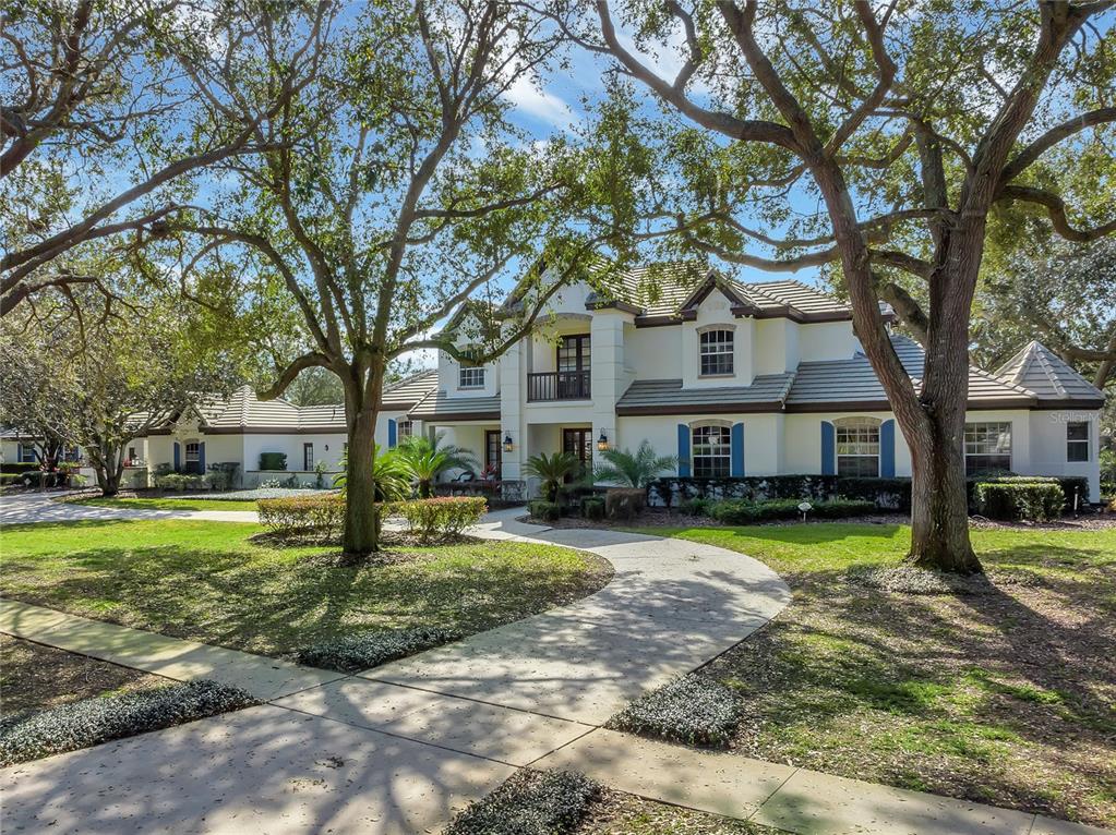 This magnificent acre estate is a must see! Coupled with the stately 4,705sqft FIVE bedroom and FOUR bath residence sits a true unicorn: a SINGLE-STORY 1BR/1.5BA (1,107sqft) guest house with private entrance, FULL kitchen, laundry, and dedicated 2 car air-conditioned garage. Through the guarded gates of Waterford Pointe, you will be impressed as you approach this expansive and unique property. The circular driveway and portico enhance the spectacular curb appeal as well as the mature landscape, grand double doors, and second story covered terrace. Upon entrance into the dramatic foyer, you will immediately appreciate the high ceilings, natural light, and outdoor living opportunities. The main floor offers a GORGEOUS kitchen and family room, breakfast nook, formal living and dining room, primary owner wing, 2 additional bedrooms (that could also be used as office space), 3 FULL bathrooms and spacious laundry room. This property showcases the best of Florida’s indoor-outdoor living as it includes a covered lanai with outdoor kitchen that overlooks the fully screened pool, spa, and play-pool as well as an additional 2 private patios. The second story features an overlook, generous loft with custom built-ins, 2 additional bedrooms and full bathroom. Further qualities and recent updates to this striking home include finished walk-in closets, wood-look plank tile, cabinetry, several appliances and light fixtures, countertops and more. This tucked away yet connected community includes a 24-hour guarded gate, boat dock with access to the skiable Lake Roberts, playground, tennis courts, and clubhouse. Opportunities to live in this special place don’t come around often – schedule your private showing today! Video & Matterport available!