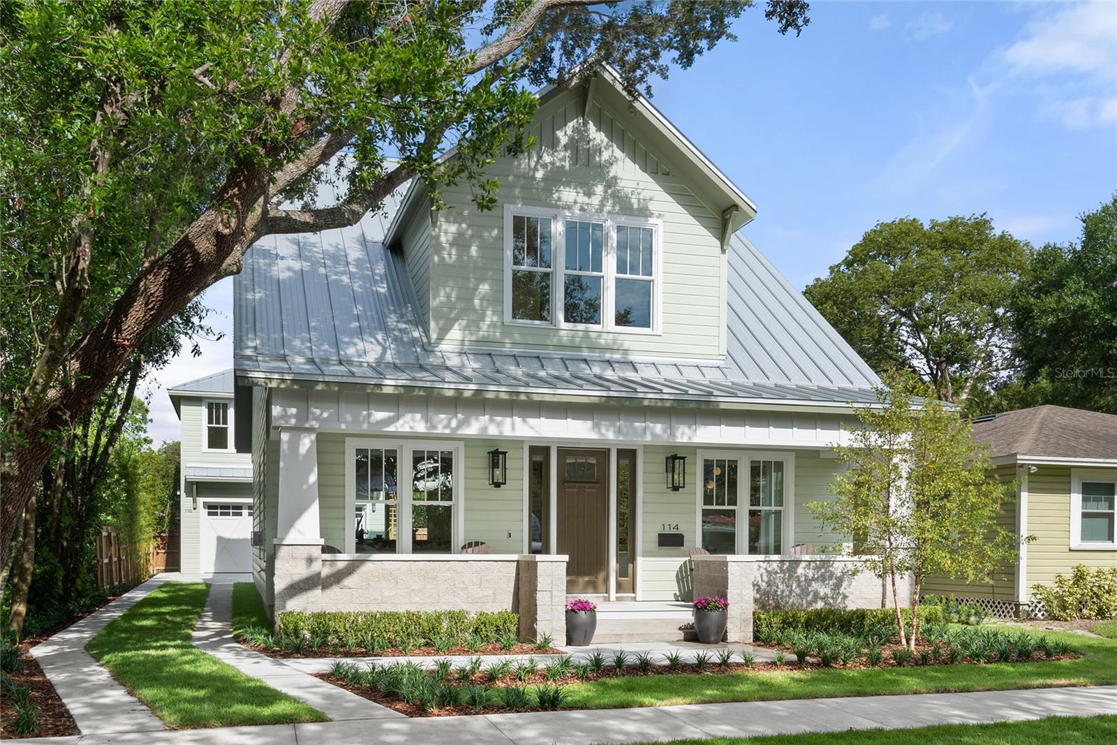 Under contract-accepting backup offers. NEW CUSTOM BUILD in the center of the very desirable HISTORIC THORNTON PARK, masterfully crafted by the distinguished E2 homes, the residential construction firm recognized for its modern design aesthetics, superior finishes & environmentally responsible building practices. The Craftsman exterior design with its inviting & expansive front porch, distinctive tapered columns, and dual gas lanterns, blends right into the classic charm of the neighborhood. The fresh & modern interior transcends expectations with over 10-foot ceilings, wire-brushed white oak flooring, and exclusive design elements that elevate this home to another status. As you enter, notice the softly illuminated stone detail lining the walls of the Living & Dining space. You can’t miss the floating staircase, an architectural masterpiece with custom railings, along with the highlighted glass wine display & the glass floored powder room, delivering more illustrations of the extraordinary design. The sophisticated & refined Kitchen offers a wonderful gathering place, centered around the double islands topped with quartzite, boasting a snack bar counter & custom built-in wood table for plenty of seating. Cooking will be a delight & made easy with the separate prep station area with additional sink. Completing to the thoughtful design, are the floor to ceiling slim shaker cabinets with integrated refrigerator & the rest of the Thermador appliance package featuring an induction cooktop, a built-in smart wi-fi oven & a microwave drawer. Next to the Kitchen, is the enviable combination Laundry Room/ Storage Pantry/ Serving Pantry with an abundance of cabinetry, honed granite counters, custom wood shelving & beverage refrigerator. Finishing out the main floor is the tucked away media room or office. The upstairs spacious loft landing, can be utilized as a bonus lounge area or office, depending on your needs. The Owner’s suite with double door entry is generously sized and features a luxury spa bath with gorgeous natural limestone, double vanities with white quartz counters, large walk-in shower with dual shower heads & a garden tub with custom wood accent wall. The other bedrooms feature deluxe en-suite baths and customized closets. Your guests will be thrilled to come to stay in the 1 bedroom/ 1 bath apartment above the garage with white oak wood flooring, kitchen with custom cabinets, quartzite counters & appliances incl. induction cooktop range, spacious bedroom, wonderful bath & a laundry closet for a stackable w/d. Apartment has its own address & electric meter, so it can also be rented out for supplemental income. If you like to entertain the triple sliding doors on the back of the house can open wide to make indoor/outdoor entertaining effortless & space on back porch allows you to create a customized built-in grilling area. Don’t forget the 2-car garage that supports the environmentally conscious lifestyle with its electric car charger outlet. Other notable features: 2 story block construction, standing seam metal roof, tankless hot water heaters, spray foam insulation, double pane windows, pre-wired for smart home, gas fireplace, natural gas connection & walkable attic for storage. If you want to live the downtown lifestyle, engage with a friendly, vibrant community with excellent walkability to Thornton Park, Lake Eola, Downtown & Milk District restaurants, shops & public houses plus Dr. Phillips Performing Arts Center & Amway Arena, then this is your new home.