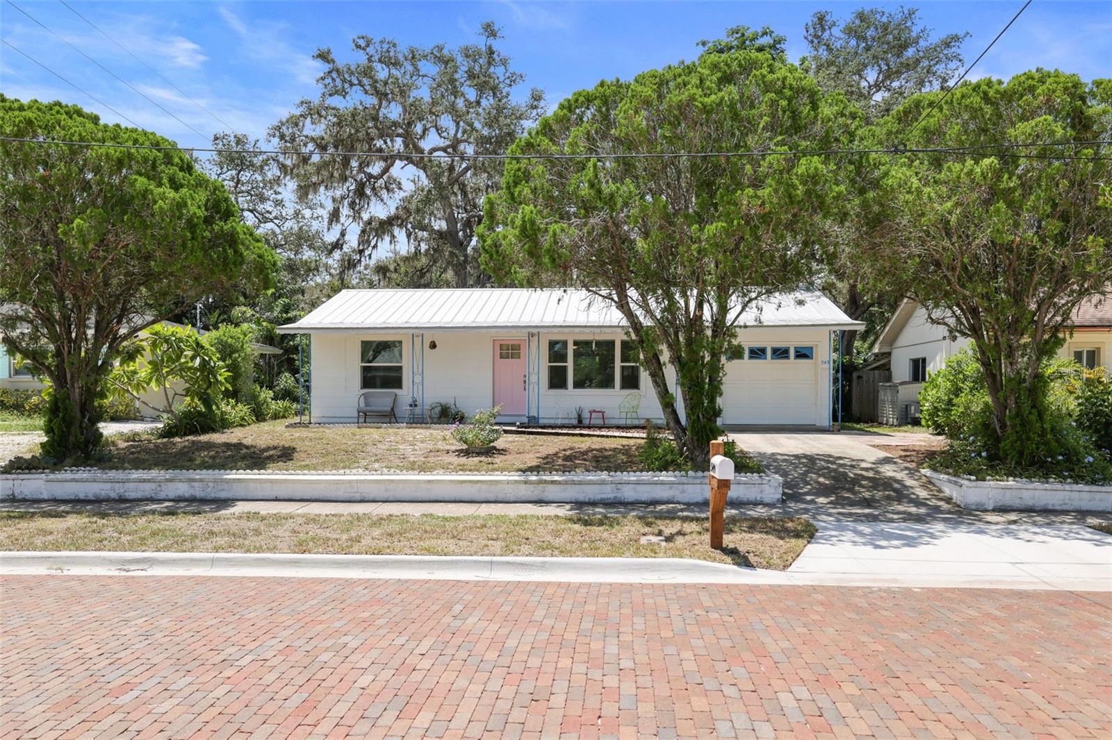 Located on one of Dunedin’s most charming brick-lined streets, 549 Locklie Street is a beautifully updated 2-bedroom, 1-bath home with a one-car garage and an unbeatable location in the heart of town. Just a short walk to vibrant Downtown Dunedin, the Pinellas Trail, and TD Ballpark—home of the Toronto Blue Jays spring training—this home places you in the center of all the action while still offering the peaceful charm of a quiet residential street.
Inside, you’ll find a thoughtfully updated interior with cream shaker cabinets, quartz countertops, stainless steel appliances, and a spacious open floor plan. The layout flows into a bright bonus sunroom in the back, perfect for a home office, reading nook, or guest space. The bathroom has been tastefully remodeled, and both bedrooms offer comfortable living and natural light.
The large, fully fenced backyard provides plenty of space for pets, play, or outdoor entertaining, and the one-car garage adds convenience and storage. Whether you’re looking for a full-time residence, seasonal home, or investment opportunity, this property checks all the boxes.
Enjoy the best of Dunedin living—bike or stroll to award-winning restaurants, breweries, boutiques, parks, and waterfront sunsets. Homes in this location rarely come available—don’t miss your chance to own a piece of Dunedin’s historic charm. Not in a flood zone, new electrical and new hurricane impact windows and doors! Schedule your showing today!