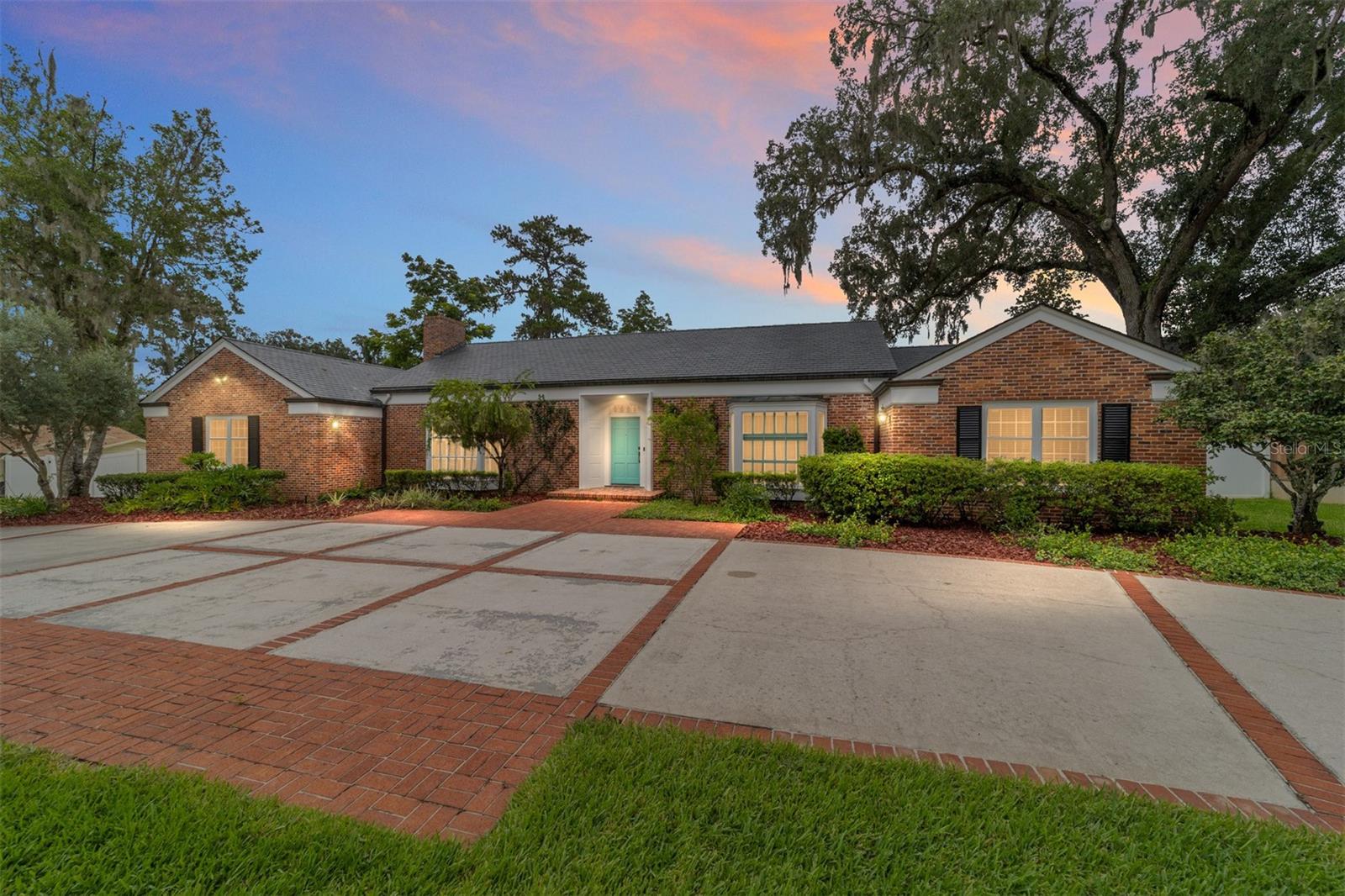 Nestled in downtown Ocala, just steps away from the historic district, this beautifully renovated 1950s home is a rare gem that blends timeless elegance with modern upgrades. From the moment you arrive, you'll be captivated by the home's charm and curb appeal featuring a large circular drive, classic brick facade, slate roof, and copper gutters. Inside, a spacious foyer welcomes you to this inviting home boasting 9–10-foot ceilings, original hardwood floors, and custom trim details throughout. The completely renovated chef's kitchen is the heart of the home, showcasing floor to ceiling wood cabinetry, a large center island and high-end finishes including a convenient pot filler- perfect for everyday living and entertaining alike. Enjoy a variety of flexible living spaces including a cozy family room, a dedicated music room, and a quiet home office. The expansive bonus room, currently used as a 4th bedroom with built-in Murphy bed and hang out area, provides endless possibilities to fit your lifestyle. The primary suite and 2 additional guest bedrooms are generously sized and feature ample closet storage. All baths- primary, guest bath, and two half baths- have been tastefully updated. Situated on an oversized lot, the fully fenced backyard offers the perfect retreat with spacious brick patio and space for gatherings, gardening, or adding a pool. Located a short golf cart ride away from the vibrant heart of downtown, you'll have convenient access to local restaurants, boutiques, and the popular Saturday fresh market. Extensive updates in the last 5 years include a full kitchen renovation, two full bathroom renovations, the addition of a half bath, the addition of a laundry room, updated plumbing, electrical and electrical panel, water heater, HVAC, and spray insulation for energy efficiency.