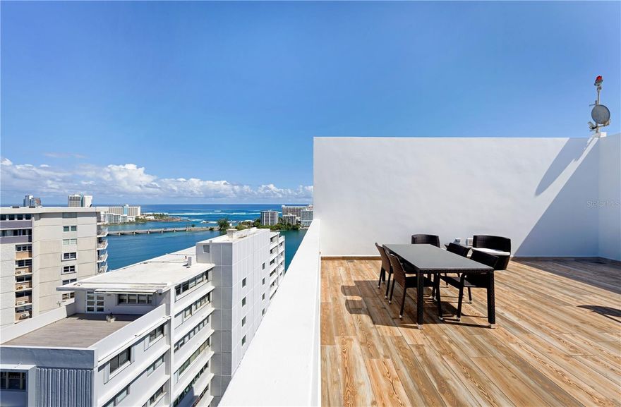 Boasting a prime location within the Miramar Arts District, this duplex penthouse with approx. 3,933 interior Sq. Ft. at Nacar Tower affords a rooftop terrace with exquisite views of the skyline and lagoon. The home features three bedrooms, three bathrooms and two powder rooms, as well as an immaculate white color palette with contrasting wood furnishing and vibrant art pieces that create a timeless design with an effortlessly elegant aesthetic. The first level tastefully displays a generously-sized open floor plan with a double-height living space and glass wall with North exposure, offering an airy ambience with an everlasting source of natural light. The gourmet eat-in kitchen with adjacent dining area and ensuite bedroom serves as the perfect setting for your culinary endeavors. Encompassing the second level of the property is an office, which can be converted into a den, and two of the bedrooms, including the primary suite with a glass enclosed bath and oversized walk-in closet. The rooftop terrace with outdoor kitchenette spans approx. 324 Sq. Ft. and includes covered/uncovered spaces that perfectly overlook San Juan's scenic cityscape, the quintessential backdrop for your ideal metropolitan lifestyle. Nacar Tower is a 16-story building just steps away from many established eateries, shopping venues and entertainment options. In close proximity to the Condado Lagoon and beach. Covered parking, water cistern and a full-power generator are among the amenities offered to residents. The Miramar Arts District is the epicenter of artistic expression on the island, with numerous museums, galleries and colorful murals that brighten up the community. Few neighborhoods provide such a unique and distinctive atmosphere for locals and visitors alike.