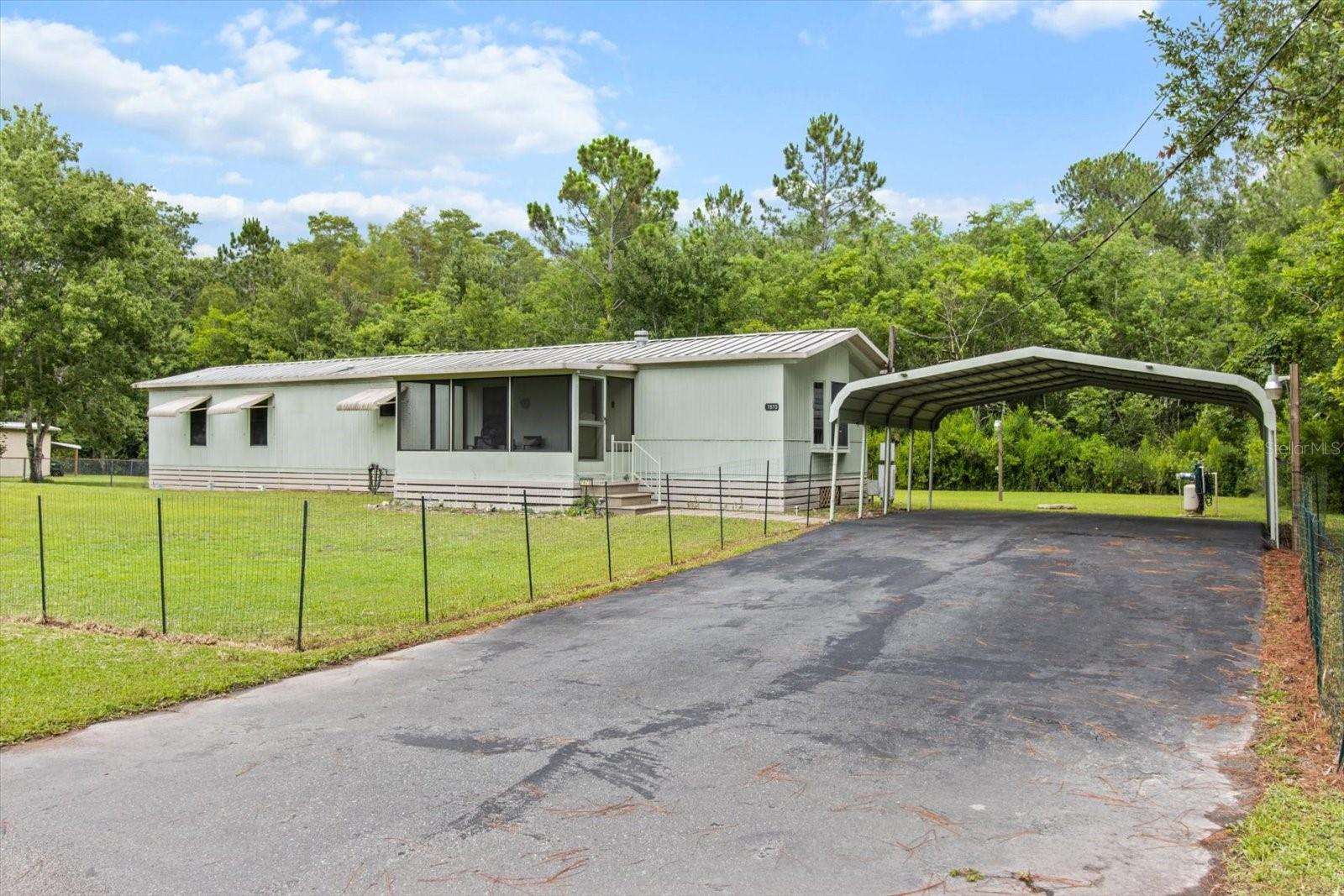 Do not miss this beautiful 2 bed, 2 bath manufactured home! A spacious and open split floor plan gives the best of living for occupants. This home comes with new vinyl plank flooring (installed 2024), a new stove, a new dishwasher, and a whole home water softener system! The covered 2-car carport keeps your vehicles protected and in the shade all day while you enjoy the breeze on the screened-in front porch. Your next home is a 1/3 of an acre on a corner lot enveloped by trees. Don't forget how easy it is to get around town when you are 1 mile from US 19 bringing multiple boat ramps, doctors offices, and shopping centers at your fingertips! Don't miss out on this amazing opportunity to experience Florida living at its best!