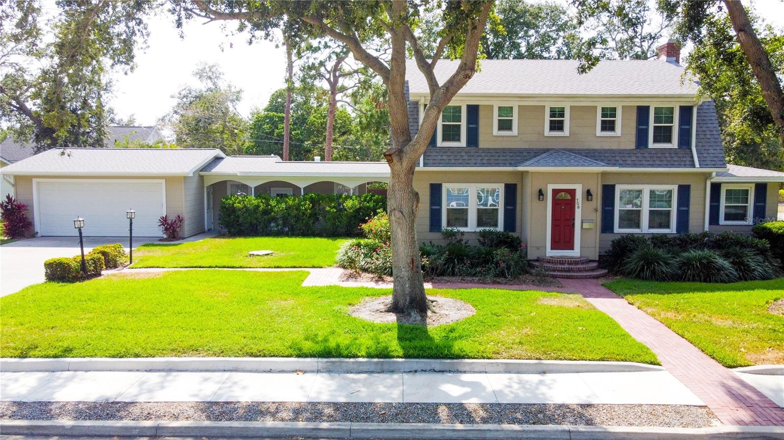 This stunning Dutch Colonial style home is one in a million. Boasting character, charm, and a fusion of old meets new, this is the perfect place to call your forever or for now home. This 4 bedroom 3 bath has everything you could hope for in its 2,885 sqft: an expansive kitchen, formal dining spaces, and many places to entertain indoors and outdoors. Some interior highlights include original restored hardwood flooring downstairs, impact hurricane windows, a decked out kitchen including a double oven and a cooktop with downdraft, and stunning custom built-ins throughout. The exterior of the home really makes this property special. With multiple patio style spaces, an outdoor kitchen with a newer grill (1 year old) and a 7 person spa (purchased 6 months ago), you truly get everything you could hope for in an outdoor entertaining space. Additionally, the 4 car garage has 2 separate shed like spaces for additional storage and use. As for the structure and bones itself, this home has had recent upgrades that extend the life of the home substantially including: a new roof in 2022, new upstairs AC in 2020, new downstairs AC in 2022, spray foam throughout the attic, and a hurricane impact 8x18 garage door. It is also seated on an expansive corner lot. Truly, the sky is the limit with this property.