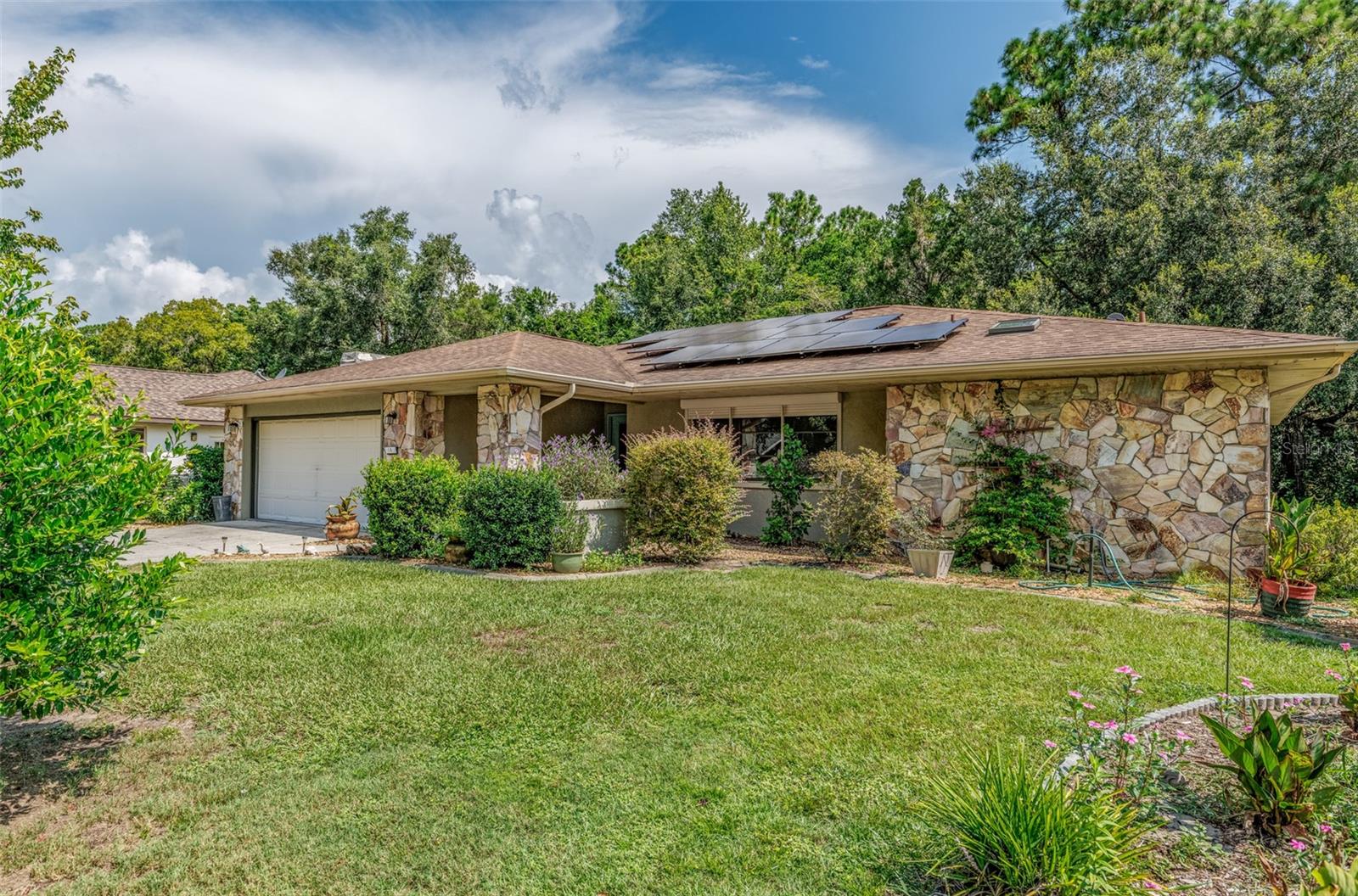 Location...Location in one of the most desirable areas of Sugarmill Woods. This 2 bedroom 2 bath 2 car garage with 1691 sq ft of living space. Featured is an excellent floor plan and whole house solar system that is leased. The current monthly lease payment is $83.00. Buyer has the option of assuming the lease payments or paying off the remaining balance. All the kitchen appliances and the washer and dryer are included. The Huge lanai overlooks the beautiful back yard and the green belt separating the neighbors isn the back. This home also has a assumable VA mortgage loan.