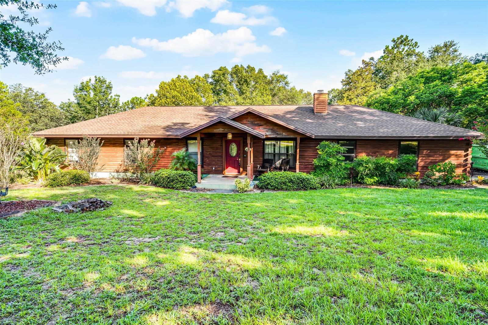 Nestled among majestic oak trees on 5.13 peaceful acres, this spacious 4-bedroom, 2-bath cedar home offers 2,240 square feet of living space and is ready for you to make it your own. A true blank slate!
The bright, open floor plan is ideal for entertaining, featuring a welcoming living room with a cozy wood-burning fireplace.
The kitchen, conveniently located off the dining room, boasts abundant oak cabinetry and generous counter space. Three bedrooms share a hall bath, while the primary suite includes a walk-in closet, private bath, and direct access to the serene sunroom.
Step outside to a private 12x12 deck—just right for morning coffee or evening relaxation—which leads to a stunning lagoon-style bottom pool.
Additional features include a 2-car garage and a peaceful country setting with the convenience of nearby amenities. This home offers the perfect blend of privacy, space, and potential!