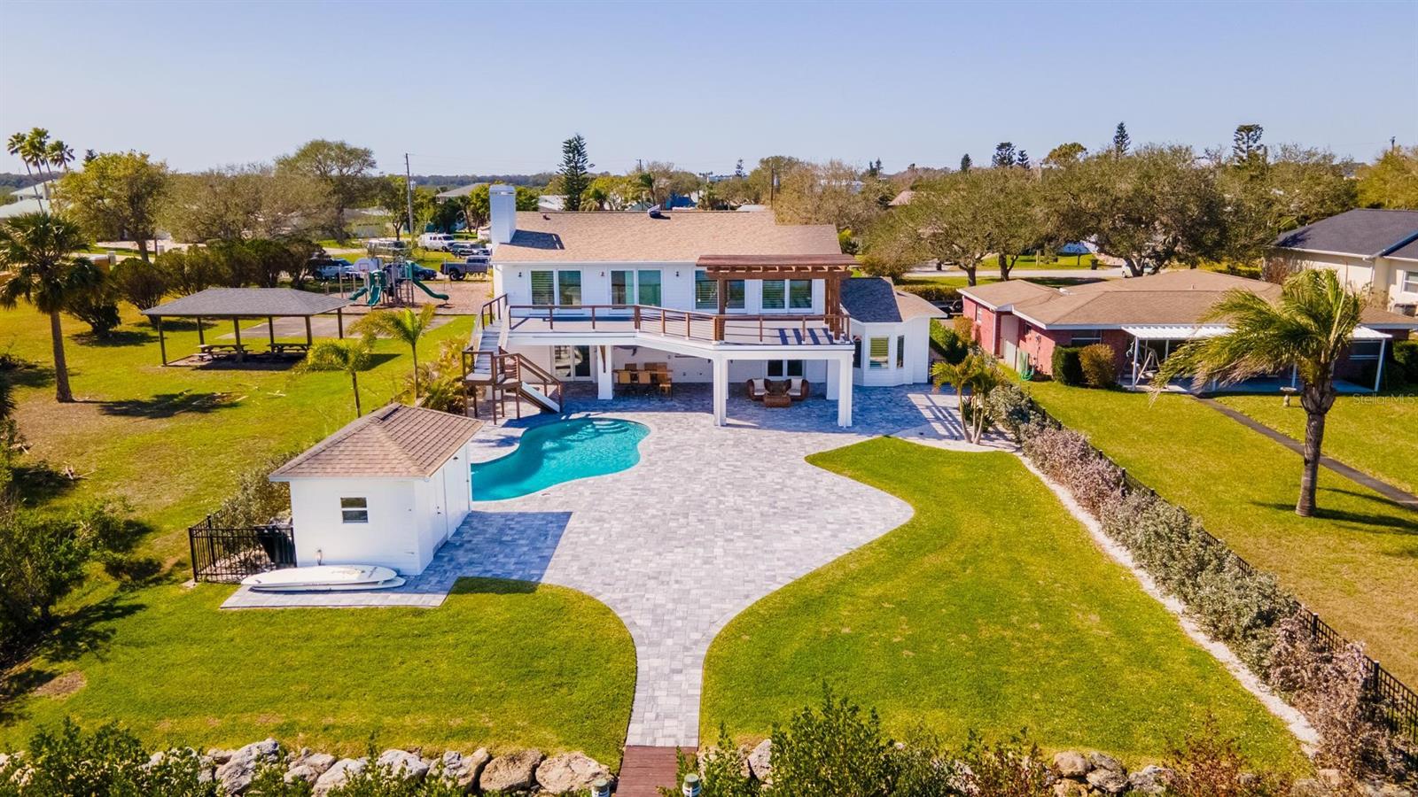 Incredible home in a premiere boating location, offering some of the best deep water access in sought after New Smyrna Beach. Inlet Shores has long been NSB’s best kept secret, boasting direct frontage on the Intracoastal Waterway - just a short ride from the Disappearing Islands and the Atlantic Ocean. Bring your boats, SUPs and kayaks and start living the Florida dream. This handsome, spacious 4 bedroom/3 bath home offers unobstructed views from nearly every room including the sprawling, spacious Master suite. The entire exterior of the home has been updated - and no expense has been spared, to create a truly awesome outdoor entertaining space. Hang out on the all new, two-story, trex deck and enjoy panoramic views of the Ponce De Leon cut, or lounge down below in the super cool outdoor den, featuring stylish tongue and groove ceilings, dual televisions and a built in bar. Additional highlights include a new dock and a 7,000 lb Tide Tamer boat lift, a complete pool remodel and brand new pavers throughout the backyard oasis and extended front driveway. The kitchen was remodeled and the roof was replaced in 2017 and the home features brand new siding and new paint, inside and out. And it’s all surrounded by lush, low maintenance, tropical landscaping complete with a new outdoor lighting and irrigation systems. The list goes on! Come discover what the locals know - and start living your best life today. ;Water: City