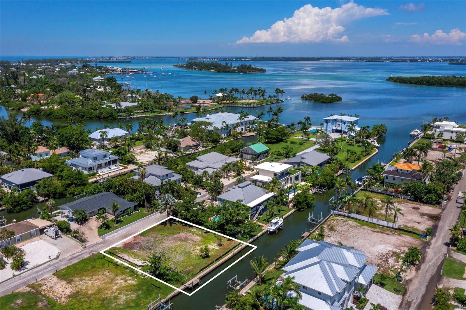 Discover a rare opportunity to build your dream home on north Longboat Key. This 100’ x 100’ lot offers 100 feet of frontage on a serene 37-foot-wide canal with no fixed bridges—perfect for boating, paddle boarding, and kayaking. Enjoy quick access to Sarasota Bay, the Intracoastal Waterway, and the Gulf of Mexico, with a number of popular boat-up restaurants just minutes away.
The quiet neighborhood setting is ideal for walking and biking, while kayakers and paddle boarders will appreciate the calm, protected waters leading to Jewfish Key, Beer Can Island, and Sister Keys. Gulf beach access is also close by, making it easy to enjoy the very best of both the Bay and Gulf lifestyle.
Just around the corner, you’ll find the charm of Longboat Village with dining favorites such as Mar Vista and Shore, along with Whitney’s, Lazy Lobster, Euphemia Haye, Harry’s Continental Kitchens, and more. This build-ready homesite combines a coveted location, walkability, and waterfront access, offering an unmatched lifestyle on Longboat Key. Call for more information.