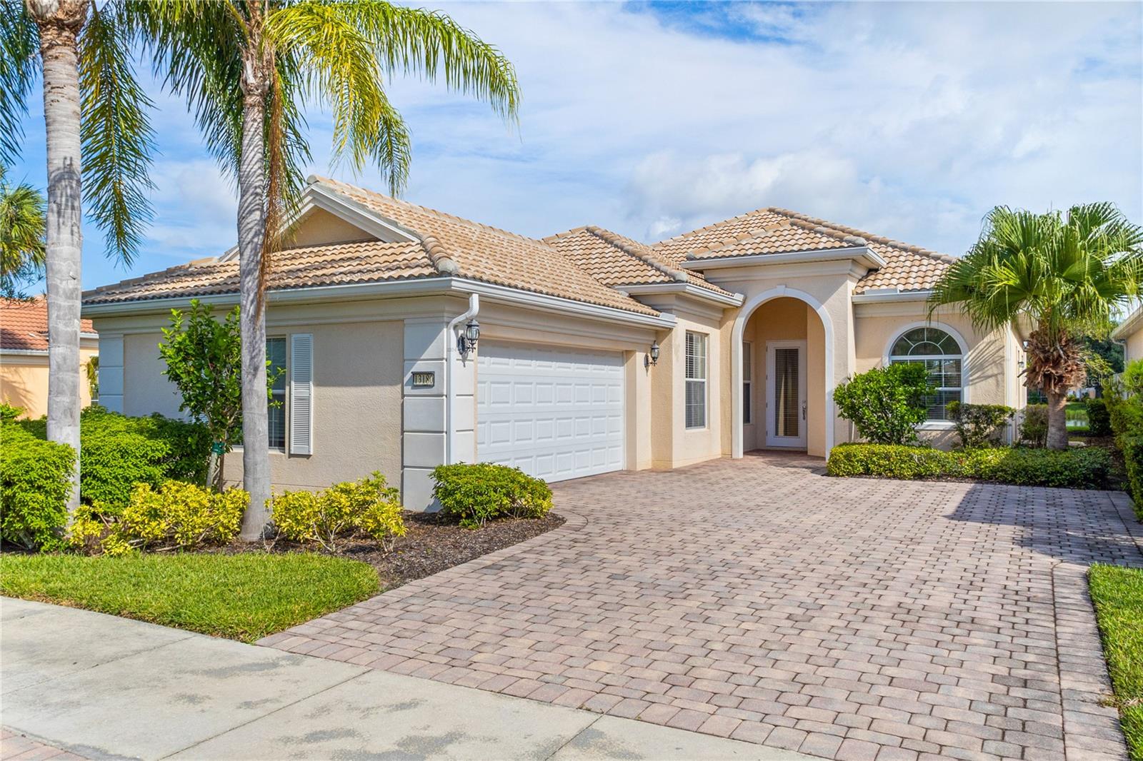 One or more photo(s) has been virtually staged. $85k price improvement! Welcome to this impeccably maintained Divosta Oakmont model, owned by a single owner. As you enter, you'll be greeted by breathtaking lake views and an open, flowing layout that seamlessly connects the Great Room, Dining Room, and Kitchen—ideal for both daily living and entertaining. The kitchen is a chef’s dream, featuring maple cabinetry, Corian countertops, and stainless steel appliances, all designed to keep you engaged with guests in the adjacent living area. High ceilings and 8-foot doors enhance the home’s spacious ambiance. The air conditioning system, just four years old, includes a transferable warranty and has been serviced biannually, with two additional service visits already paid for. The primary suite serves as a serene retreat with ample closet space and generously sized his and hers bathrooms. The split floor plan ensures privacy, with two additional bedrooms and a guest bathroom on the opposite side of the home. A versatile den offers a quiet space for work or relaxation and can be easily closed off for uninterrupted focus. The large laundry room features a drop sink and cabinets for added storage, leading to an oversized side-entry garage with an extended driveway. Step outside to the expansive covered and screened lanai, perfect for dining, entertaining, or simply relaxing while taking in the gentle breeze and panoramic water views. Privacy walls between you and your neighbors further enhance your outdoor enjoyment. Islandwalk is a pristine 830-acre gated community surrounded by lakes and preserves. With a full-time Lifestyle Director, the community offers a wealth of events, clubs, and activities to foster a vibrant social life. Amenities include three amenity buildings, a heated lagoon pool, a heated outdoor lap pool, bocce ball courts, pickleball courts, Har-Tru tennis courts, a dog park, a playground, a basketball court, and a community garden. The beautifully maintained grounds feature miles of nature and biking trails, Venetian bridges, and scenic water views. The location is exceptionally convenient, with a rear exit to Cool Today Park, the Atlanta Braves Spring Training Stadium, and the new Downtown Wellen Park, all just a short bike or golf cart ride away. Enjoy easy access to shopping, medical services, dining, and the stunning Gulf Beaches, with quick access to I-75. This home is being offered turnkey with all furnishings, dishes, cookware, silverware, TVs, and more. Don’t miss this opportunity to embrace the Florida sunshine and relaxed lifestyle!