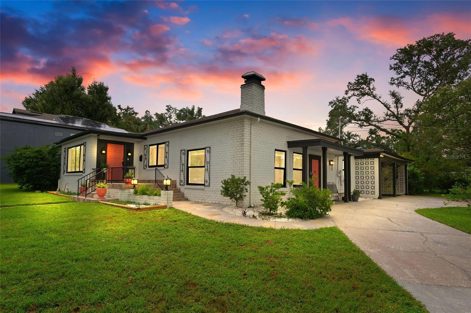 Once and a while something truly special comes around. Presenting 1016 W Kentucky Ave- an amazing mid-century gem nestled in one of Tampa’s hottest and most coveted neighborhoods, Riverside Heights. Situated on a sprawling 0.36-acre corner double lot, this solid masonry-built home offers the rare combination of vintage character, contemporary updates, and prime location. Boasting 3 bedrooms, 3 full bathrooms, and just over 1,800 square feet of thoughtfully laid out living space, this split-level pool home has been lovingly updated with tasteful touches while still maintaining its vintage charm. Step inside this the stylish foyer opening up into the warm and inviting living space showcasing gorgeous original oak hardwood floors, beautiful archways, and a fully updated kitchen with sleek cabinetry, quartz counters, stainless appliances. A large formal dining room and flexible front sitting area flow seamlessly from the heart of the home, offering endless options for entertaining. The bright, open layout continues into the sunken family room, anchored by a full brick wood-burning fireplace, vintage mosaic tile flooring, and multiple large windows that flood the space with natural light. On the opposite wing of the house, your stunning primary suite awaits featuring a 2 closet spaces, including a spacious walk-in closet in your luxurious private en-suite bath- equipped with: dual sink vanity, marble tile, brushed gold fixtures, and a stunning walk-in shower.
The 2nd bathroom is one of the cutest you'll find with a fun retro coastal look with vintage flooring and pink wall tile and wallpaper.
The 3rd bedroom all the hallway features beautiful warm stained wood trim and shutters.
The 2nd spacious bedroom has gorgeous parquet wood floors and loads of large windows with wood shutters that flood the room with natural light and views of the backyard. Just off the family room is a spacious and convenient mudroom with washer/dryer, storage areas, direct access to and from the covered carport, and a charming 3rd Mediterranean style full bathroom with which connects to the pool area. Outside, the oversized backyard is a true private oasis. Enjoy lush landscaping, garden space, multiple patio zones, and a private in-ground pool- ideal for lounging, playing, or entertaining guests. There’s even a large shed for storage or workshop use. Enjoy the convenience of a spacious two-car covered carport with a circular driveway, offering ample parking and easy access. This block construction home was built to last and remained completely unscathed during past storms. Throughout the home, you’ll find charming vintage details blended seamlessly with bold, designer-forward finishes, giving it a one-of-a-kind personality. Ideally positioned on the corner of Ridge Avenue and Kentucky, the property is framed by classic brick-lined streets that add to its timeless appeal. All of this just off the Hillsborough River, only minutes from Armature Works, Water Street, Tampa Riverwalk, Channelside, and major highways, making commuting or exploring Tampa a breeze. This rare double lot offers incredible potential for expansion, redevelopment, or simply enjoying the added space and privacy. With timeless character, thoughtful updates, and a prime location in one of Tampa’s most desirable neighborhoods, this property is a standout opportunity you won’t want to miss.