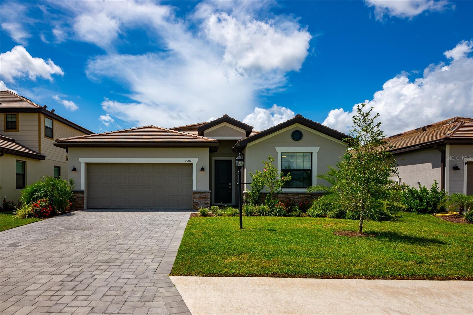 Welcome to your Florida dream home in Lorraine Lakes, one of Lakewood Ranch's premier resort-style communities! Perfectly positioned directly across from a tranquil green park space, this beautifully maintained 4-bedroom, 3-bathroom residence offers peaceful views and modern finishes. Stepping through the front door, you will be greeted by an open-concept floor plan that maximizes natural light and flow. The expansive living area seamlessly connects to a chef-inspired kitchen featuring granite countertops, stainless steel appliances, a large island with seating space and plenty of cabinet space - perfect for entertaining or everyday living. The primary suite is your personal retreat, complete with a spa-like en-suite bathroom with dual vanities, walk in shower, and spacious walk-in closet. Two additional bedrooms have flexibility for guests, a home office or family members. The fourth bedroom features a complete en-suite private bathroom with tub/shower. Step outside to your covered screened and pavered lanai ideal for morning coffee or evening sunsets. Home comes with transferrable warranties from builder. Reasons to love living in Lorraine Lakes - Gated resort style community with a stunning clubhouse. Resort pool, splash pad, and poolside cafe and bar and full-service restaurant for your convenience dine in or take out. Fitness center, indoor basketball court, tennis, pickleball, volleyball and more. Scenic walking trails, lakes, and parks. Full time lifestyle director with a calendar of social events. Located in Lakewood Ranch - top-rated schools, nearby shopping, dining and only a short drive to Sarasota's beautiful beaches. Whether you are looking for a peaceful escape or an active community lifestyle - this property delivers it all - with a bonus serene park setting right outside your front door. Call to schedule your private tour today. This is more than a home it's a lifestyle!