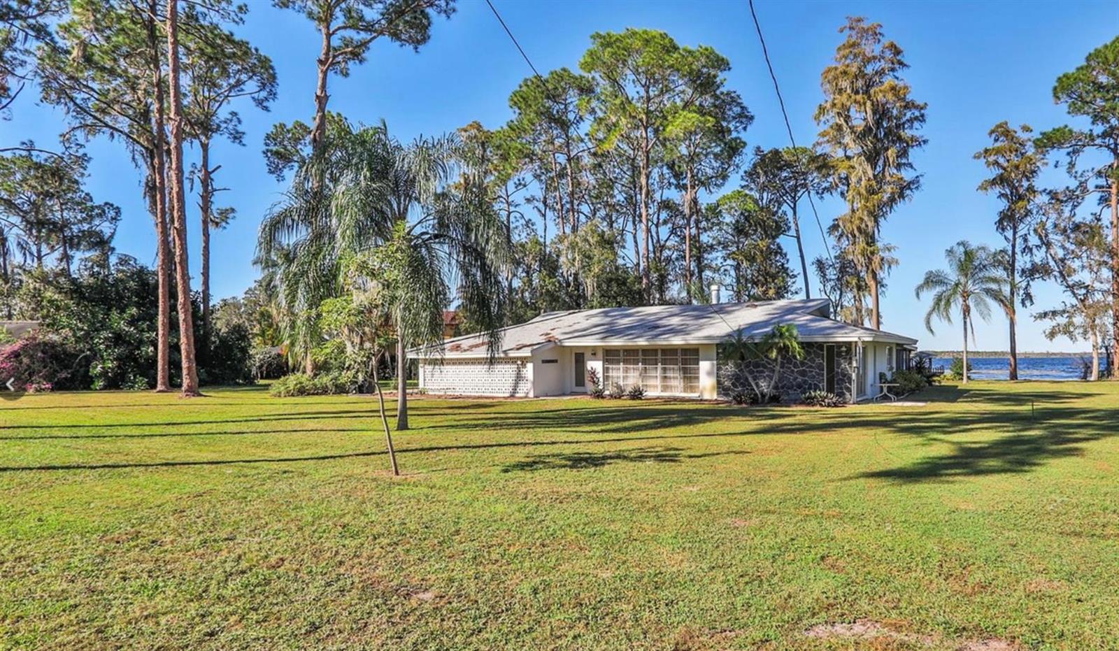 A rare opportunity awaits with this exceptional triple-lot property on the renowned Butler Chain of Lakes—just minutes from the coveted Dr. Phillips area and with no HOA restrictions. Offering prime lakefront access, this oversized parcel is priced primarily for its land value and is the perfect canvas for creating your dream estate.
The current residence is dated but move-in ready, giving you the flexibility to live on-site while planning your custom build. Picture a modern lakefront masterpiece with walls of glass framing sweeping water views, sprawling outdoor terraces designed for entertaining, and a private dock for boating, fishing, or paddleboarding right from your backyard.
Set within minutes of Dr. Phillips’ premier shopping, fine dining, and A-rated schools, this property combines tranquility with convenience in one of Orlando’s most desirable neighborhoods. With direct access to the Butler Chain of Lakes, it’s the ultimate setting for luxury lakefront living.
Don’t miss your chance to create a one-of-a-kind retreat in this unbeatable location. Sale includes Lots 2, 3, and 4.