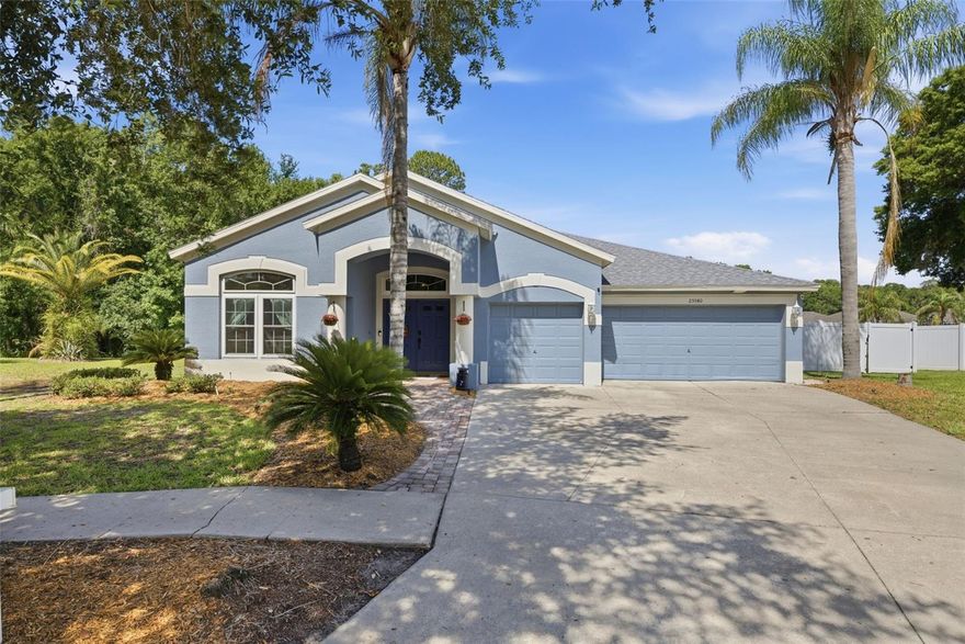 Welcome to the highly sought-after Lexington Oaks Golf Club community, where Florida living meets breathtaking natural surroundings. This impeccably maintained home offers 60 feet of serene POND and CONSERVATION frontage, creating a peaceful, private backdrop best enjoyed from the screened lanai featuring an inviting in-ground POOL and SPA. Whether you’re entertaining or unwinding at the end of the day, this outdoor oasis captures the essence of Florida living.  From the moment you arrive, the home’s impressive curb appeal stands out with upgraded pavers, mature palm landscaping that beautifully frame the property. Elegant French front doors welcome you into a spacious and thoughtfully designed interior.  Inside, the desirable SPLIT FLOOR PLAN offers the perfect balance of privacy and functionality. Formal living and dining rooms provide elegant spaces for hosting gatherings and special occasions, while the open-concept main living areas create a seamless flow for everyday living. The kitchen is well-appointed with stainless steel appliances, abundant cabinetry, a breakfast bar, center cooking island. An indoor laundry room adds additional convenience.  The home also features a spacious 3-car garage, offering ample room for vehicles, storage, and everyday practicality. Major updates have already been completed for peace of mind, roof and HVAC system replaced in 2022, doors & windows in 2023. This exceptional residence combines modern upgrades and resort-style outdoor amenities within one of Wesley Chapel’s most established golf communities. Lexington Oaks offers residents access to outstanding amenities, including a pay-as-you-play championship 18-hole golf course, fitness center, heated community pool, tennis courts, basketball and volleyball courts, playground, splash pad, clubhouse, and Omari’s Bar & Grill. Conveniently located near top-rated schools, hospitals, restaurants, shopping centers, and major roadways, this home truly offers the best of location, lifestyle, and comfort.