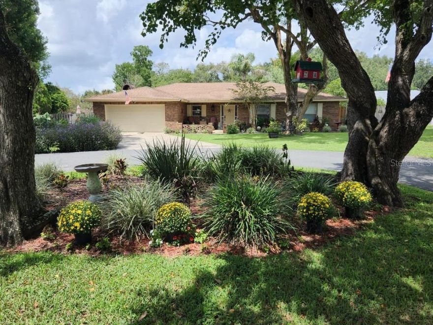 This beautifully updated home is ready to move into. Relax while floating in the pool, walking in your certified butterfly garden, or just sitting on the screened porch listening to the waterfall.  The well-appointed kitchen has shaker cabinets, granite countertops, a breakfast bar, and stainless-steel appliances. Under cabinet lighting, pull-out lower cabinet shelves, and a stacked stone accent wall behind stove. The openness from the Kitchen, dining, living, and family rooms gives a nice area to entertain your family and friends.  Built-in shelves surround the Wood Burning Fireplace in the family room. Laminate flooring with carpet in bedrooms.  Lots of updates.  Energy efficient windows and the house is wired for a generator if the power goes out.
