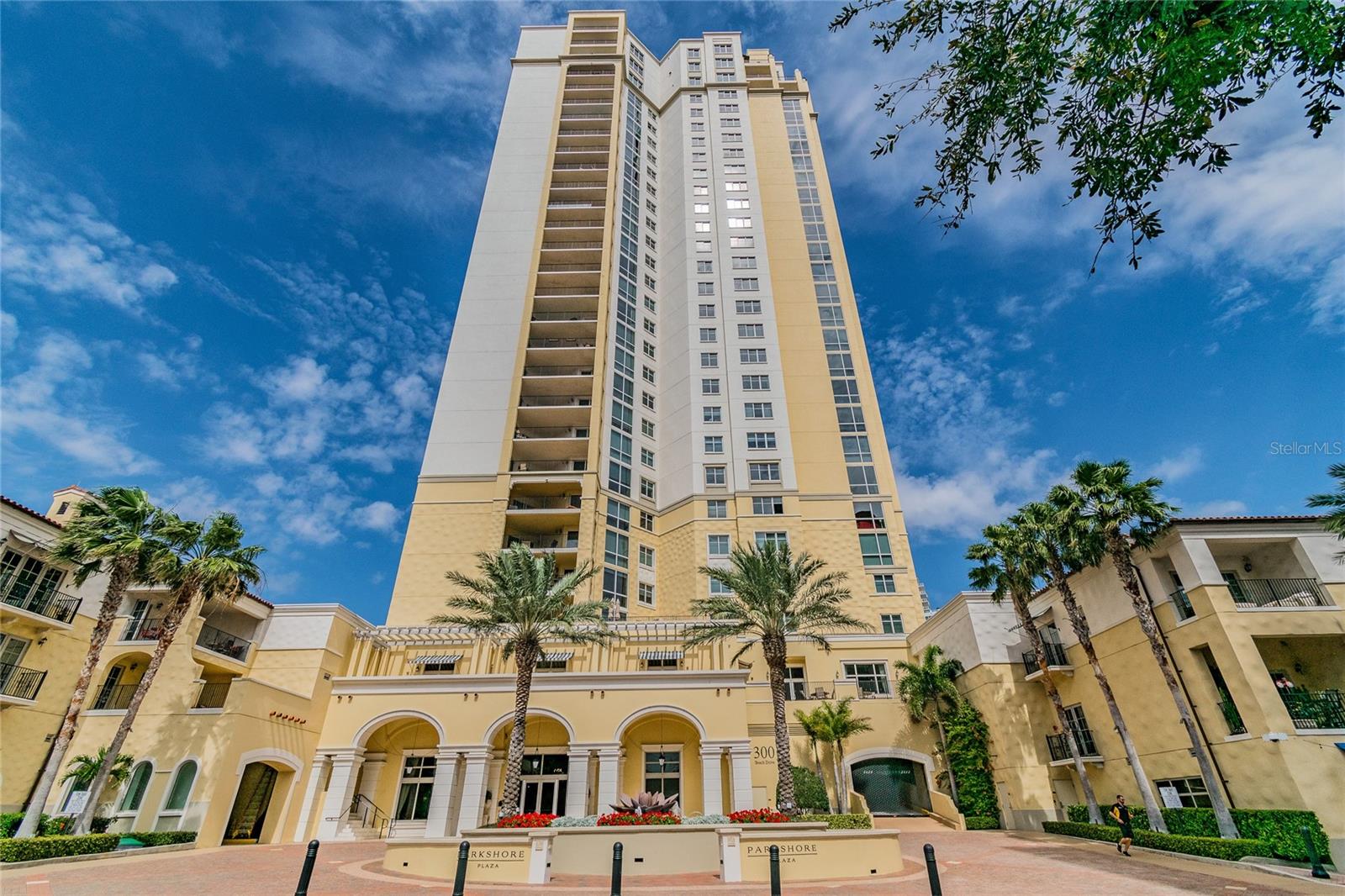 Welcome to the world of luxury at the Parkshore Plaza with the privacy of a home and all the amenities of a fine hotel. Unit 702 of 300 Beach Drive is an exquisite waterfront residence which redefines urban living, espousing functionality, clean lines, and simplicity without ornate detailing. Offering hints at midcentury modern design in living room and kitchen, the lights also incorporate wood elements and bright color, blending with the earth tones in the kitchen. A spacious three-bedroom, three-bath haven adorned with elegant finishes and an abundance of natural light. The semi-open concept layout seamlessly connects the living, dining, and kitchen areas, creating the perfect space for both relaxation and entertainment. Your primary bedroom and en suite is designed in a minimalistic style, providing a Zen quality to the space, with openness and lack of clutter. You will appreciate the beauty and simplicity of your en suite. Materials used such as glass, large porcelain tile, wood, chrome, and quartz create this tranquil retreat. From your private balcony, indulge in breathtaking vistas of the sparkling waters and picturesque skyline, creating a captivating backdrop for every moment. The gourmet kitchen boasts stainless steel appliances, sleek granite countertops, and ample storage, making it a haven for culinary enthusiasts. Second bath renovation incorporates a modern Victorian tile design, large pearl color subway tiles in the shower and hardware from the Kohler Devonshire collection, captures the elegance of a bygone era. Nestled in the heart of downtown, 300 Beach Drive places you at the center of the city's vibrant cultural scene, with galleries, theaters, and dining options just steps away. Whether you're strolling along the waterfront or enjoying the local entertainment, every day is an opportunity to immerse yourself in the best of St. Petersburg. Experience the pinnacle of urban living in this luxurious condominium, where every detail has been thoughtfully curated for your comfort and enjoyment. Don't miss the chance to make Unit 702 at 300 Beach Drive your own and embrace a lifestyle that truly defines sophistication and contemporary minimalistic living.