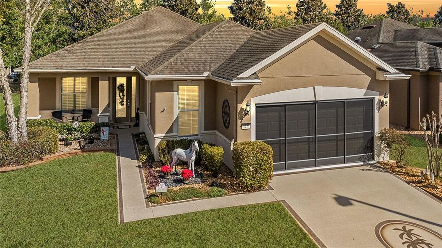 Resort-style living comes naturally in this spacious Shenandoah model, ideally located in the Arlington neighborhood of the gated, 55+ Stone Creek Golf Course Community. Thoughtfully designed for comfort and flexibility, this home offers 2 bedrooms, 2 baths, a versatile flex room, an extended garage, and a large climate-controlled lanai for year-round enjoyment. Curb appeal impresses immediately with a painted driveway and walkway, mature landscaping, and a welcoming front porch with a glass-inset entry door. Inside, the light-filled living area features luxury vinyl plank flooring and Plantation shutters throughout, creating a clean and cohesive look. The gathering room showcases high ceilings, elegant crown molding, and a full wall of sliding glass doors that open seamlessly to the climate-controlled four-season lanai. This inviting space includes a bead-board ceiling and finished window ledges, making it perfect for relaxing or entertaining. The flex room, enhanced with barn doors and a striking shiplap accent wall, offers an ideal setting for a home office or den. The Chef’s kitchen is beautifully appointed with brand-new stainless-steel appliances, granite countertops and sink, upgraded cabinetry with lower pull-outs, a stylish glass tile backsplash, and a convenient pantry. The connecting casual dining area is accented with striking wainscoting and sliders leading to the lanai for effortless indoor-outdoor flow. The Owner’s Suite provides a peaceful retreat with a spacious walk-in closet and French doors opening to the en suite bath. The bath includes a double-sink vanity with dressing table, a large step-in shower with a transom window for natural light, and a private water closet. Outdoor living is equally inviting. An aluminum-fenced backyard with mature landscaping, a paver patio, and a pergola creates a private oasis for evening dinners, morning coffee, or unwinding after a round of golf. The two-car extended garage offers plenty of space for two golf carts and features an insulated garage attic and garage doors. Thoughtful upgrades include high-rise toilets, a new water heater, a new water softener, a WiFi thermostat, a WiFi sprinkler system, and a new roof scheduled for installation, all offering valuable peace of mind. Embrace the exceptional lifestyle of this vibrant community, featuring a 24/7 staffed gated entrance for security and peace of mind. Luxury-inspired amenities include heated pools, a state-of-the-art fitness center, a spa, and relaxing hot tubs and saunas. Stay active with pickleball, bocce, tennis, and a softball field, while a dedicated lifestyle staff curates entertainment, activities, and special events to foster connections. Just beyond the gates, enjoy a golf course, pro shop, and restaurant, perfect for socializing and unwinding. Make your move today and experience resort-style living at its finest!