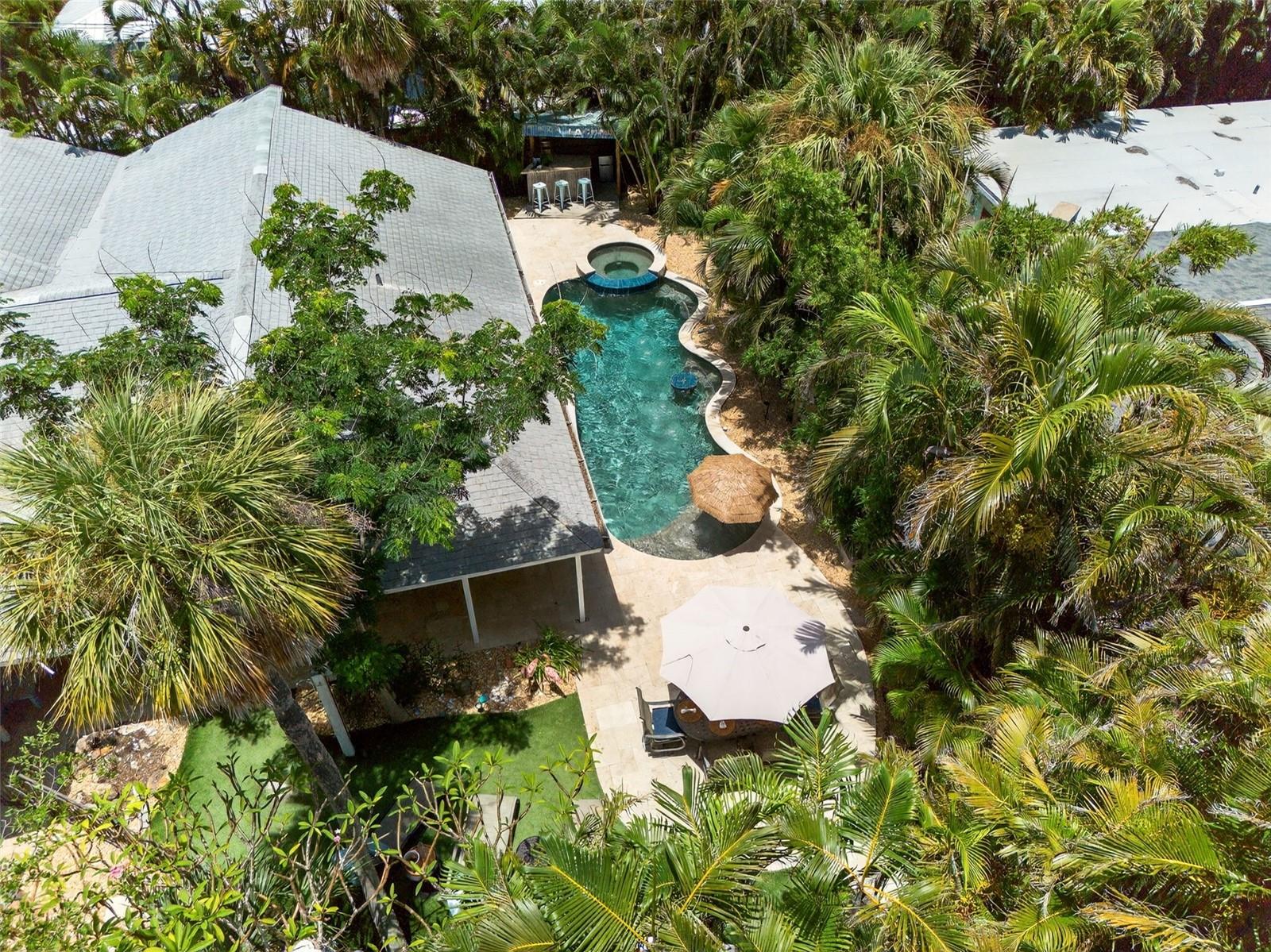 Welcome to Your Dream Vacation Getaway
Surrounded by world-class beaches, fantastic restaurants, and charming shops, this TURN-KEY FURNISHED 4-bedroom, 3-bathroom pool home is perfectly situated in the heart of Anna Maria Island. It is just 3 blocks from the beach! A proven income property with exceptional reviews and bookings in place, this home offers both a serene retreat and a smart investment.
Nestled on a spacious corner lot with lush native landscaping and swaying palms, the home features wide covered porches that overlook an outdoor oasis. Step into your private paradise with a sparkling lagoon-style pool and spa. Surrounded by tropical greenery, the built-in spa with water jets, thatched umbrella, and natural stone-tiled deck create a resort-like ambiance. A fun Tiki bar, outdoor shower, and ample lounge space add to the perfect setting for entertaining or relaxing after a day at the beach. Outdoor living continues with a covered porch and shaded dining area, ideal for morning coffee or evening cocktails.
Inside, the home boasts a completely remodeled, open-concept living area and a large eat-in kitchen, perfect for gathering with family and friends. The split floor plan includes four private bedrooms and two spacious bathrooms on the main floor. Upstairs, a generous loft offers a third bathroom, a fifth bonus bedroom with a queen bed, and a cozy reading nook.
An attached 1-car garage provides convenient storage for all your beach gear and golf cart.
Don’t miss your chance to own this tropical retreat. Book your private showing today!